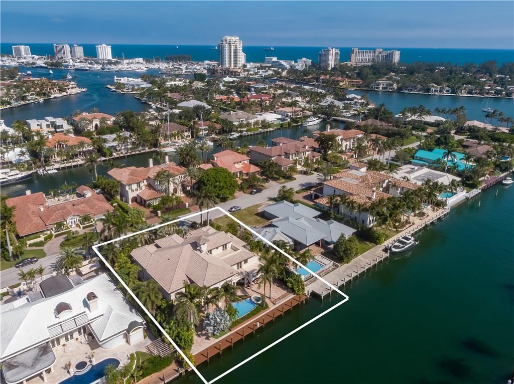 Exquisitely updated Harbor Beach Gated Estate. 110' of deep waterfront on a wide canal & turning basin, mins to the Intracoastal. Gourmet kitchen opens to family rm, wet bar & wine closet. 2 story ceilings, open floor plan, game rm, home theater, office, library, exercise rm, elevator, lavish master suite. Lutron & Crestron systems. Full home generator. 5 large balconies, large covered loggias. S. facing pool & spa. Guard house entry, web cameras & beach club. Sq ft from imap tax