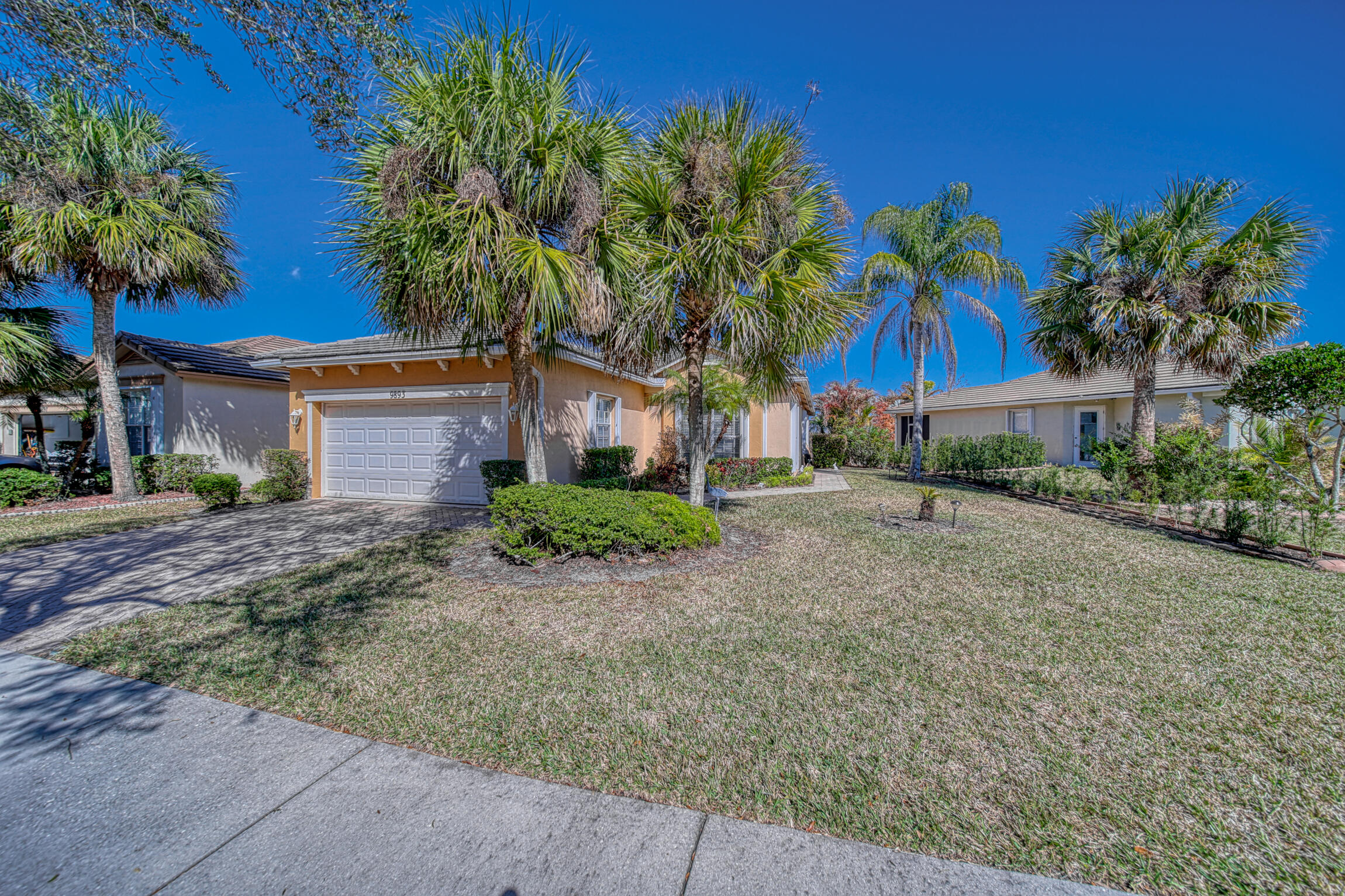 Welcome to this well-kept Georgian model home in the gated community of Heritage Oaks within Tradition. This 3-bed, 2-bath home with a 2-car garage features tile and vinyl flooring throughout and a bright, open layout. The family room is designed to have an optimal view of the backyard and pond. The kitchen offers stainless steel appliances, breakfast table and lots of counterspace. The accordion shutters provide added peace of mind. Enjoy serene water views from the screened patio and extended paver patio—perfect for relaxing or entertaining. The neighborhood amenities include a community pool, clubhouse, fitness center, cable and internet. Move-in ready and ideally located for convenient Florida living.