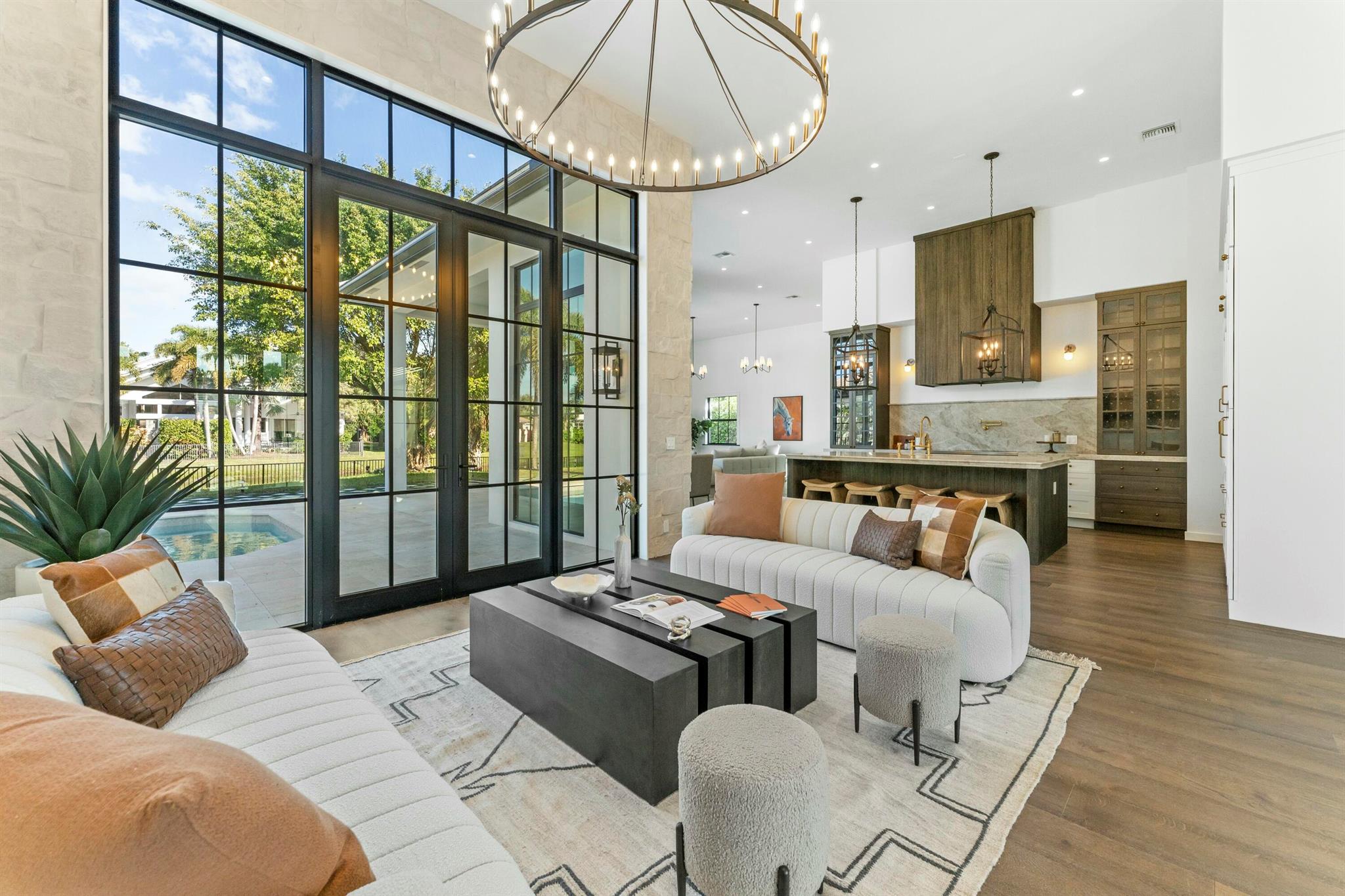 Step into a masterfully reimagined 3-bedroom, 3-bathroom residence in the prestigious Palm Beach Polo community. Completely redesigned and gut-renovated with top-tier materials, this exquisite home offers an unparalleled blend of sophistication and comfort. Two versatile flex spaces provide endless possibilities—ideal for a home office, formal dining, den, or guest suite. The coveted natural light floods in through 12-foot windows and doors, accentuating the rich dark wood floors and striking natural limestone accent walls. A chef's dream kitchen boasts Thermador appliances and real brass fixtures, ensuring every detail exudes luxury.Nestled on a quiet, tree-lined street, this home features an excellent split floor plan for privacy and ease of living.