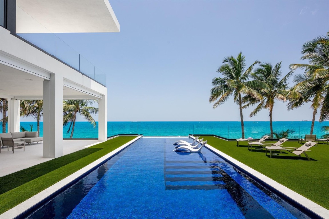 A Beachfront paradise like no other boasting 12,667ACSF, embraced by 100’ of pristine ocean frontage, crafted by Bomar Builders. Prepare to be mesmerized as you step onto the entertaining level – great room w/ fireplace & soaring ceilings and chef's kitchen equipped w/ double SubZero & Miele appliances complete with hidden housekeepers office. Third floor is adorned with guest suites & an AM bar beckons you to savor peaceful mornings. Primary suite w/double closets opens onto an alluring balcony, offering a view of the tranquil ocean. Find the finest finishes like Lutron lighting & Honeywell home system throughout. Infinity edge pool melds with the horizon & expansive rooftop deck, screened-in summer kitchen, cabana bath & outdoor shower invite you to immerse yourself in beachfront living.