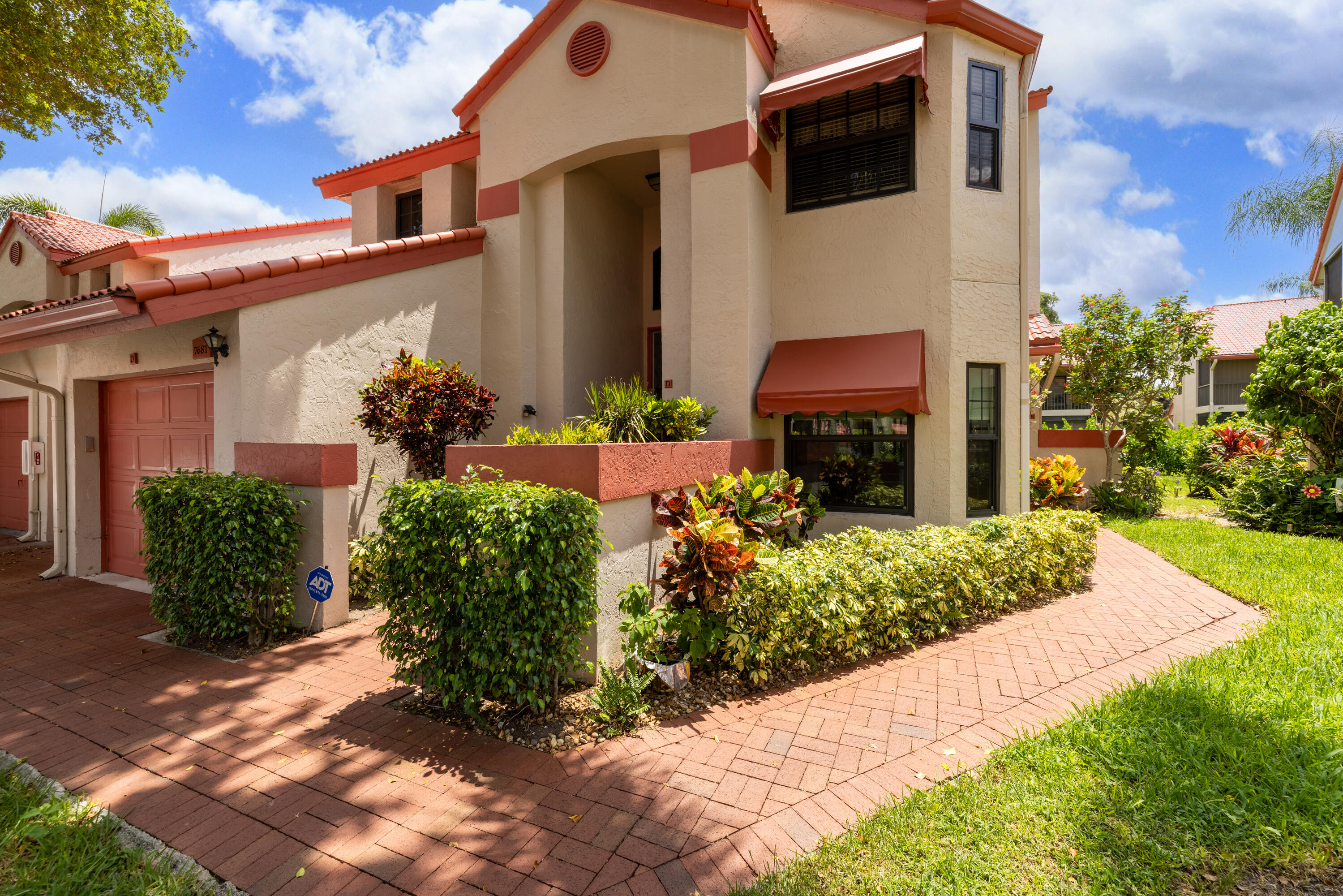 This beautiful 3 bedroom, 2 bath, second floor coach home offers a bright, open living space with vaulted ceilings. It features NEW IMPACT WINDOWS (2025), newer AC (2024), and a new water heater (2025). The chef's kitchen includes upgraded cabinets topped with moldings, newer stainless steel appliances, convenient pull-out drawers in the pantry, wood flooring, and updated fans. The primary and guest spaces offer excellent storage, including a bonus closet in the 1 car garage. The guest bath has an updated vanity, fixtures, and lighting. The enclosed, air-conditioned lanai with ceiling fans is a comfortable extension of the living area. The sellers, long time seasonal owners, have maintained the property with care. Lexington Club offers a vibrant, resort style lifestyle with a great pool,  hot tub, sauna, tennis and pickleball courts, shuffleboard, shows, seasonal events, clubs, fitness classes, card games, and more. All measurements are approximate. Take a look at the 3D walkthrough.
