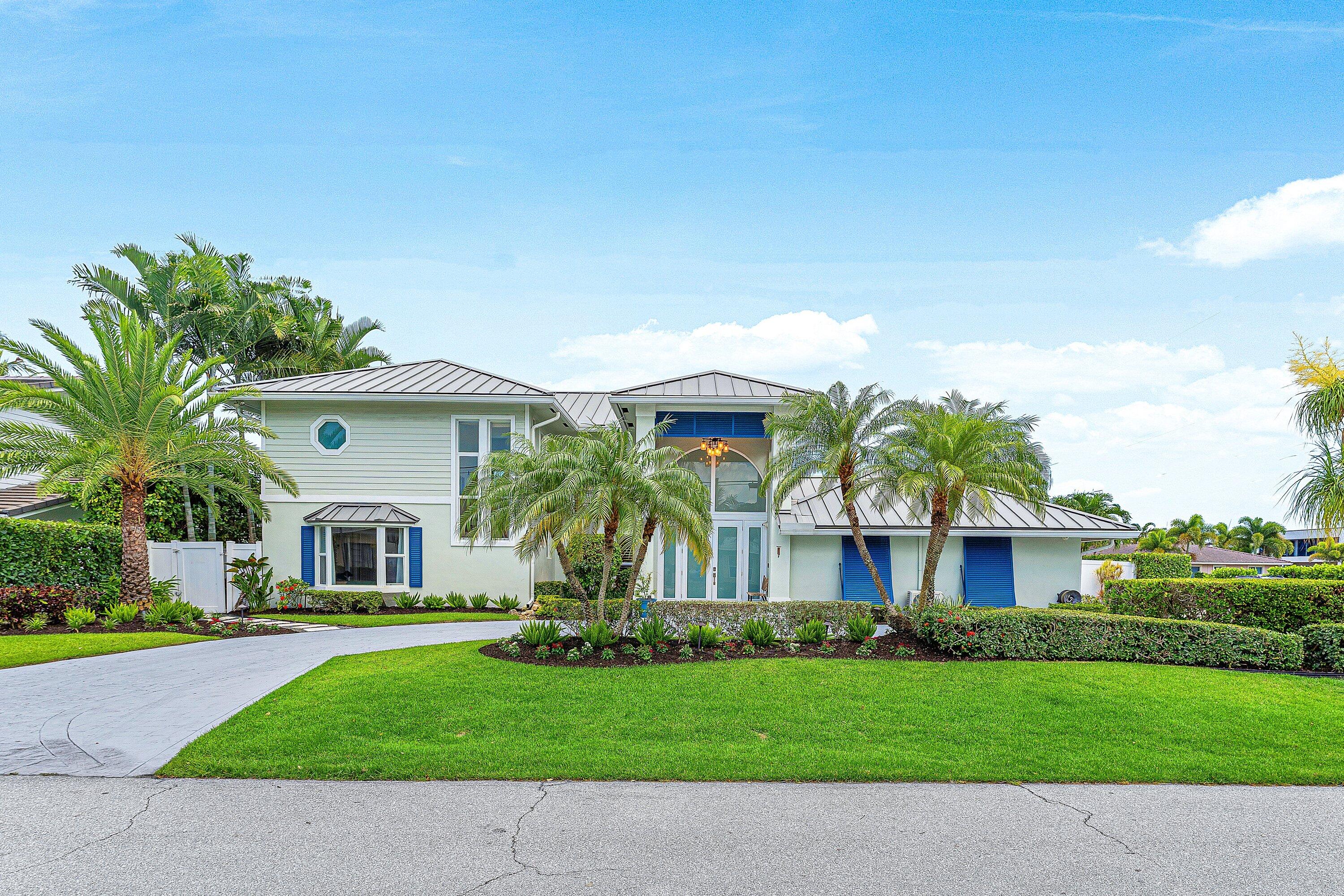 A rare opportunity to own a fully renovated waterfront masterpiece offering 95' of waterfrontage and direct Intracoastal access with no fixed bridges. Situated on a prime corner lot, this 5-bedroom, 3-bath residence was completely reimagined in 2017 and showcases soaring ceilings, an open-concept design, a luxurious upstairs primary suite with private balcony, spa-inspired bath, and oversized walk-in closet. Outdoor living is elevated with a resort-style pool, separate hot tub, and fully equipped summer kitchen. The boating enthusiast will appreciate the newer seawall, dock, 14,000-pound boat lift, jet ski dock, electric power station, dockside storage, and ice maker. A truly turnkey waterfront retreat designed for those who demand the very best of the South Florida lifestyle. Experience the best of South Florida waterfront living in this meticulously renovated 5-bedroom, 3-bath residence situated on a premier corner lot with 95 feet of waterfront and direct ocean access with no fixed bridges. Completely transformed from top to bottom in 2017, this exceptional home offers the perfect blend of luxury, comfort, and boating convenience.  Designed for both everyday living and entertaining, the open-concept floor plan features soaring ceilings, abundant natural light, a spacious living area, formal dining space, and a beautifully appointed kitchen with extensive cabinetry, induction range, and generous prep space. Dishwasher is brand new, refrigerator & washer/dryer are 2 years old, range & microwave are 8 years old, water heater is 7 years old, hvac systems are 3 & 6 years old!  An incredible laundry/mudroom includes a built-in office workstation, laundry sink, and ample storage.  The private upstairs primary suite serves as a true retreat, featuring its own waterfront patio with new tile, a spa-inspired bathroom with dual sink vanity, separate soaking tub and shower, and an oversized walk-in closet.   The cabana bath provides convenient access to the backyard and pool area.  Step outside to your own tropical paradise. Enjoy a sparkling in-ground pool, separate hot tub, expansive patio areas, and a fully equipped outdoor kitchen complete with built-in grill and side searing station. Boaters will appreciate the newer seawall, dock, 14,000-pound boat lift, jet ski dock, dockside storage cabinets, electric power station, and built-in ice maker—everything needed for effortless days on the water.  Additional highlights include a new metal roof (2021), a 2-car garage with epoxy flooring and custom storage cabinets, peaceful waterfall feature by front door, and the peace of mind that comes from nearly every major component of the home having been updated or replaced.  Perfectly positioned in one of Boca Raton's most desirable waterfront locations, this turnkey residence delivers an unparalleled lifestyle where luxury, boating, and coastal living come together seamlessly.