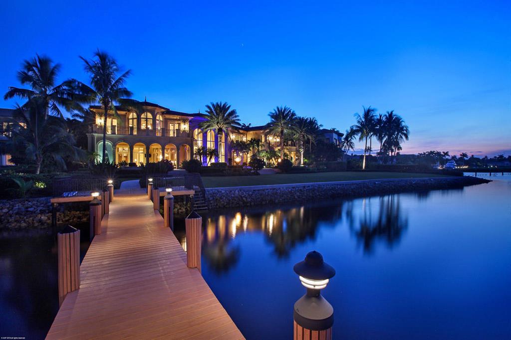 DIRECT INTRACOASTAL WITH 190' OF WATER FRONTAGE... When entering this gated signature estate you know you are in true paradise. This home features 7 bedrooms, with 2 separate guest homes each with their own private entrances, custom walnut office with wet bar & views of Intracoastal, state of the art gym with sauna and therapy spa, dome dining room with seating for 12, 3 laundry rooms, fireplace, all hand carved marble columns, 8 car garage (can have lifts to increase to 10), 2 golf cart garage, high-end EVERYTHING. The luxurious master suite has his and hers baths, custom closets, balcony over looking waterways with a bonus room and bath attached. Enjoy hours of relaxation under the covered patio with summer kitchen, ceiling fans and electric drop down screens.