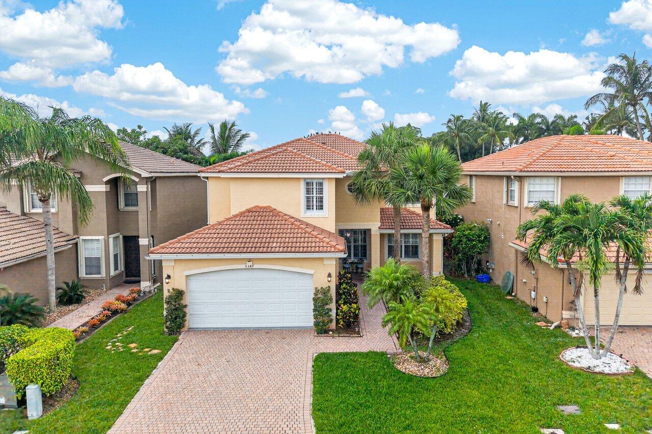 Get ready to fall in love with this beautifully maintained two-story pool home in the heart of Greenacres! A quiet retreat.    Designed for both comfort and efficiency, this exceptional residence features a 2-car garage with a Tesla charger, owned solar panels, Plantation Shutters throughout, and a spacious open floor plan that seamlessly blends indoor and outdoor living. Relax in your private backyard oasis complete with a sparkling pool, lush tropical landscaping, and plenty of space to entertain family and friends.  From the inviting curb appeal to the bright, stylish interiors, Partially furnished this home is truly move-in ready and offers the perfect Florida lifestyle.   Pre-Approval & POF