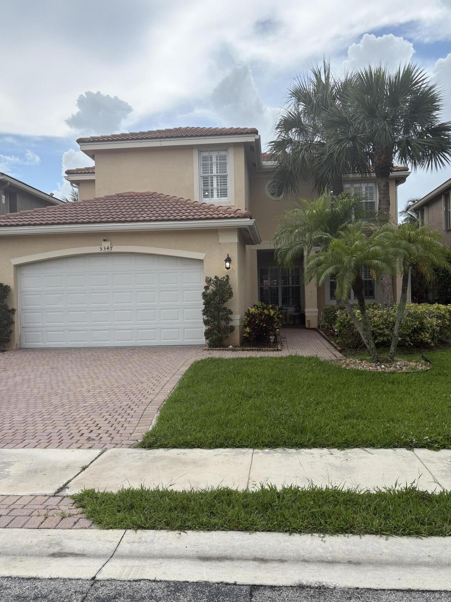 Get ready to fall in love with this beautifully maintained two-story pool home in the heart of Greenacres! A quiet retreat.    Designed for both comfort and efficiency, this exceptional residence features a 2-car garage with a Tesla charger, owned solar panels, and a spacious open floor plan that seamlessly blends indoor and outdoor living. Relax in your private backyard oasis complete with a sparkling pool, lush tropical landscaping, and plenty of space to entertain family and friends.  From the inviting curb appeal to the bright, stylish interiors, Partially furnished this home is truly move-in ready and offers the perfect Florida lifestyle.   Pre-Approval & POF