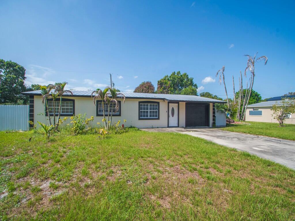 Beautifully maintained CBS home just outside Fort Pierce city limits and only minutes from the beaches! This move-in-ready home features tile flooring throughout, a spacious family room, dining area, and a large primary suite with a private bath. French doors open to a covered patio, pavered fire pit area, and a fully fenced backyard, perfect for entertaining. Plenty of parking for boats, RVs, trailers, and equipment, plus additional storage space. Metal roof installed in 2018.