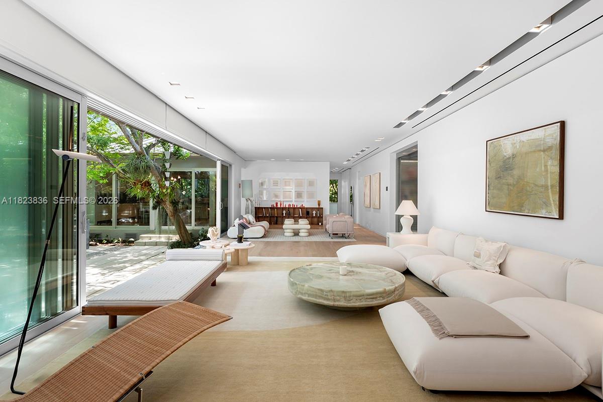 Tucked away on La Gorce Island, this artful Mid-Century Modern home offers refined living w/ tropical serenity. Envisioned by legendary landscape architect Raymond Jungles, lush gardens create a secluded oasis around the home’s iconic architecture Telescoping glass doors, oak floors, & floating walls define expansive social spaces including a great room, formal dining, 2 offices, and a state-of-the-art theater. The chef’s kitchen, framed by a picture window & arched ceiling, & equipped with sleek Gaggenau appliances. The primary suite boasts a grand spa bath with dual rain showers, tub, and lounge area. Outside, discover a whimsical retreat with koi pond, a louvered entry, and a resort-style pool w/ cabana. This is a rare corner lot in one of Miami Beach’s most coveted neighborhoods.