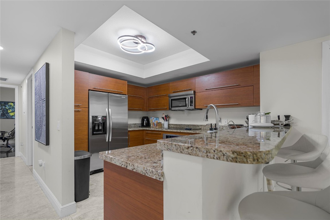 Experience upscale living in this beautifully updated 3-bedroom, 3-bathroom condo located in a prestigious high-rise community just steps from Sawgrass Mills Mall, fine dining, and entertainment. This residence features a modern open-concept layout, ideal for both relaxing and entertaining. Enjoy peace of mind with 24-hour security, and the convenience of two assigned covered garage parking spaces. Each bedroom offers generous space and privacy, with three full bathrooms providing ultimate comfort for you and your guests. Whether you're enjoying the views from your private balcony or exploring the vibrant neighborhood, this condo offers a perfect blend of luxury, location, and lifestyle