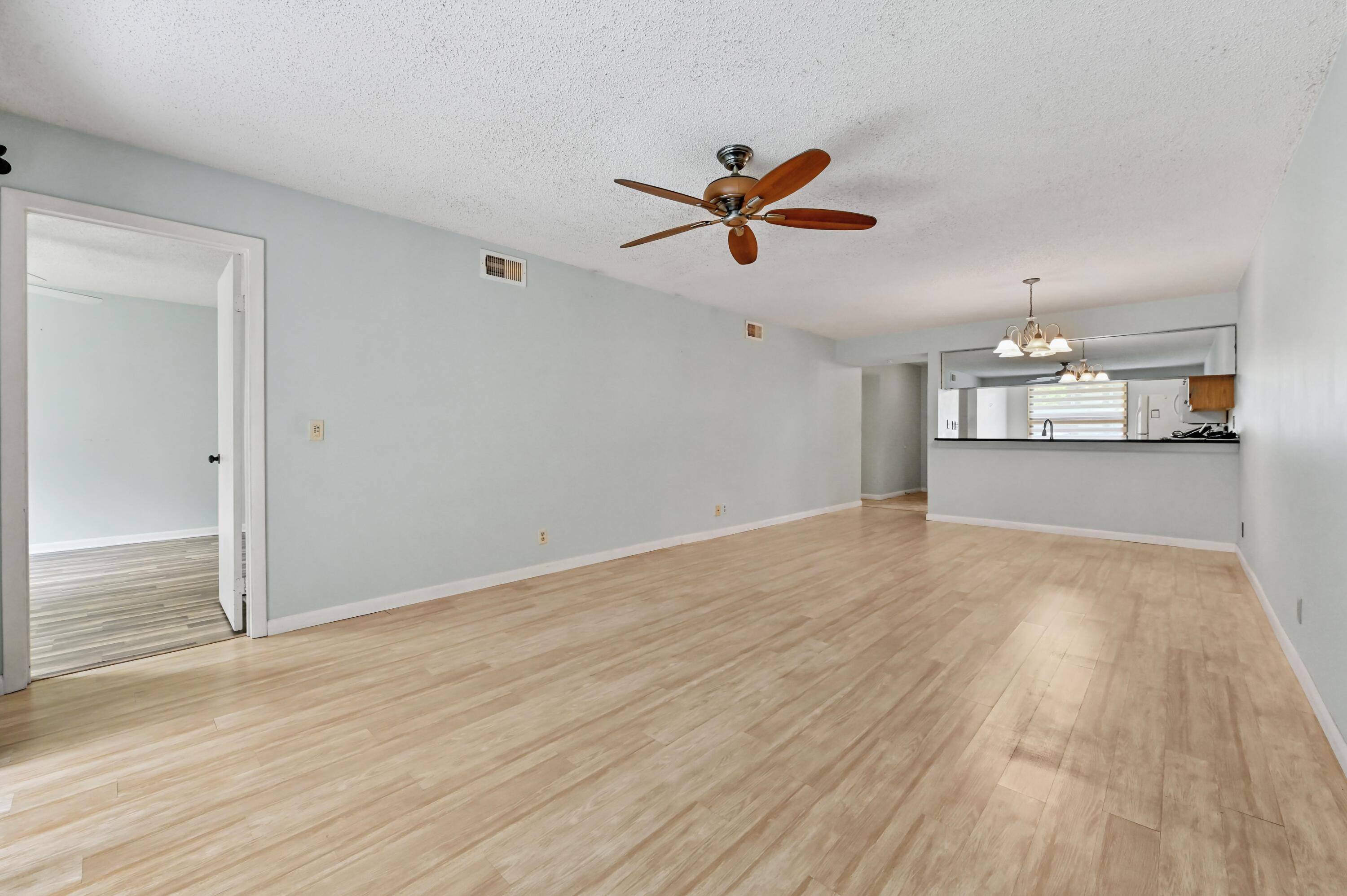Welcome to Sabal Ridge Condo, a well-maintained 2-bedroom, 2-bathroom first-floor unit offering comfort and convenience in a desirable community with a 2025 AC. This spacious 1,200 sq ft two-story condo features a welcoming foyer that leads into a bright and open living and dining area, enhanced by tile and laminate flooring throughout.  The kitchen is thoughtfully designed with granite countertops, wooden cabinetry, and a set of appliances providing both functionality and style. The split-bedroom layout offers privacy, with a generously sized primary suite and a well-appointed second bedroom.   Enjoy peace of mind with accordion shutters on all windows, along with a covered and screened back patio complete with roll-up shutters, perfect for relaxing or entertaining year-round.  This unit combines practical upgrades with comfortable living spaces, making it an excellent choice for full-time residents or seasonal living.