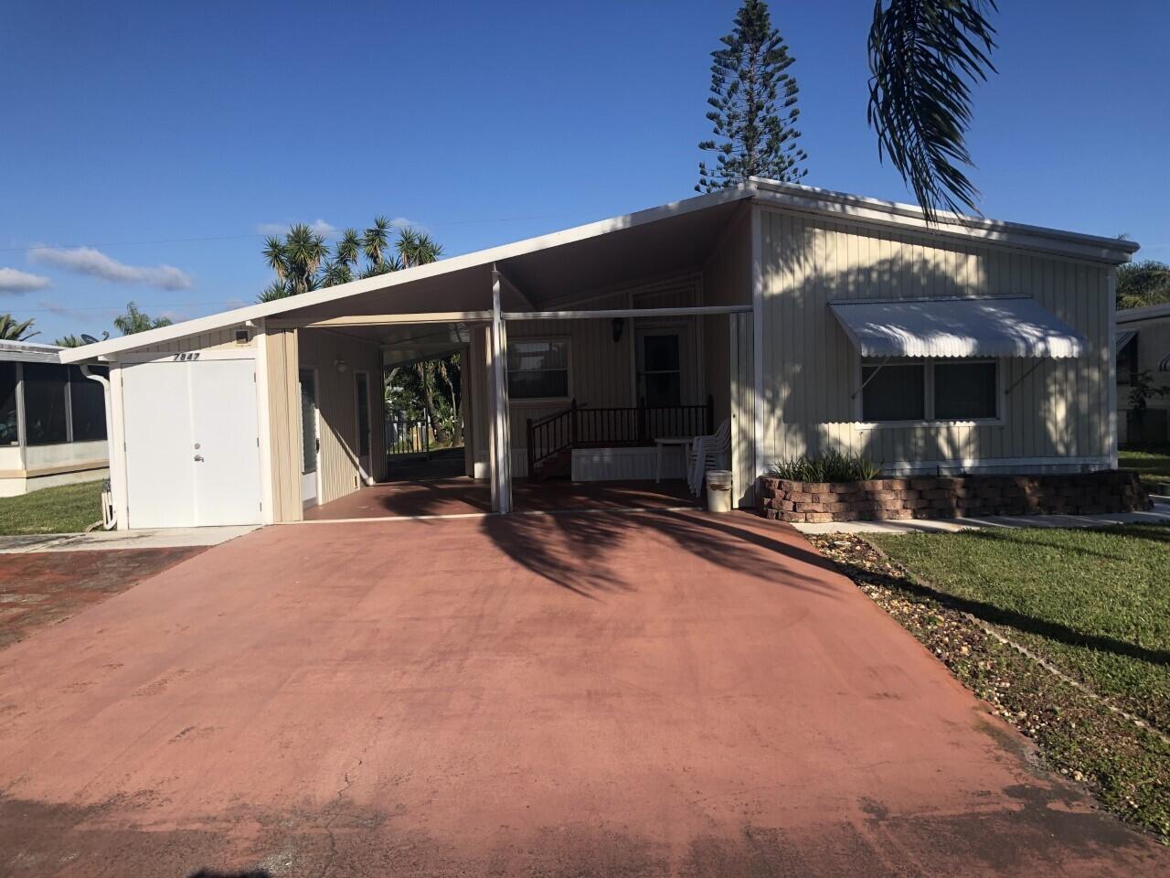 A very nice 2-bedroom, 2-bathroom, 1168 square foot manufactured home in Hobe Sound. The home has a large covered area on the front of the unit with a lockable work/storage are attached. It also has a nice covered and screened Lanai off the primary bedroom.