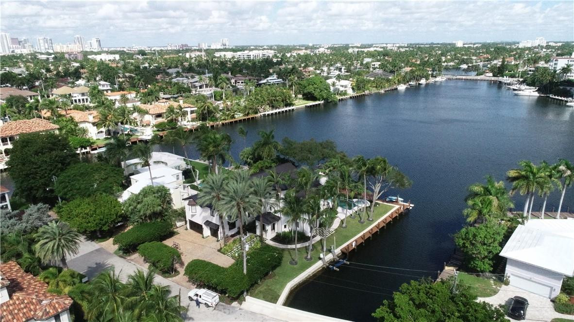 "BALI COASTAL" LAS OLAS RIVIERA ISLES PANORAMIC WIDE WATER VIEWS OF SUNSET LAKE FROM 1/3 ACRE INTERIOR POINT LOT ESTATE  WITH 250' OF DOCKAGE! WALK TO FAMOUS FORT LAUDERDALE BEACH & LAS OLAS!  TOTALLY RENOVATED TOP TO BOTTOM IN 2021 IN A TRANSITIONAL CONTEMPORARY STYLE!  8 BEDROOMS, 8.5 BATHS 6500 SF UNDER AIR ELEVATOR & 3 CAR GARAGE! 8.1 FOOT FINISHED FLOOR ELEVATION! ARCHITECT BOB TUTHILL! GRAND FOYER & LIVING ROOM SOARING 30 FOOT CEILINGS! TEAK HARDWOOD FLOORS THAT HAVE JUST BEEN REFINISHED! BRAND NEW METAL SEAM ROOF! NEW DESIGNER ITALIAN GAS QUARTZ KITCHEN! CRESTRON SMART HOUSE! LA FINESTRA WINDOW AND DOOR PACKAGE! PREMIUM DETAILED PROPERTY INSIDE AND OUT! MASSIVE OUTDOOR LIVING WITH MATURE OAKS &COCONUT TREES! BACKYARD PICKS UP SOUTH EASTERLY BREEZES FOR GRAND SOUTH FLORIDA LIVING!