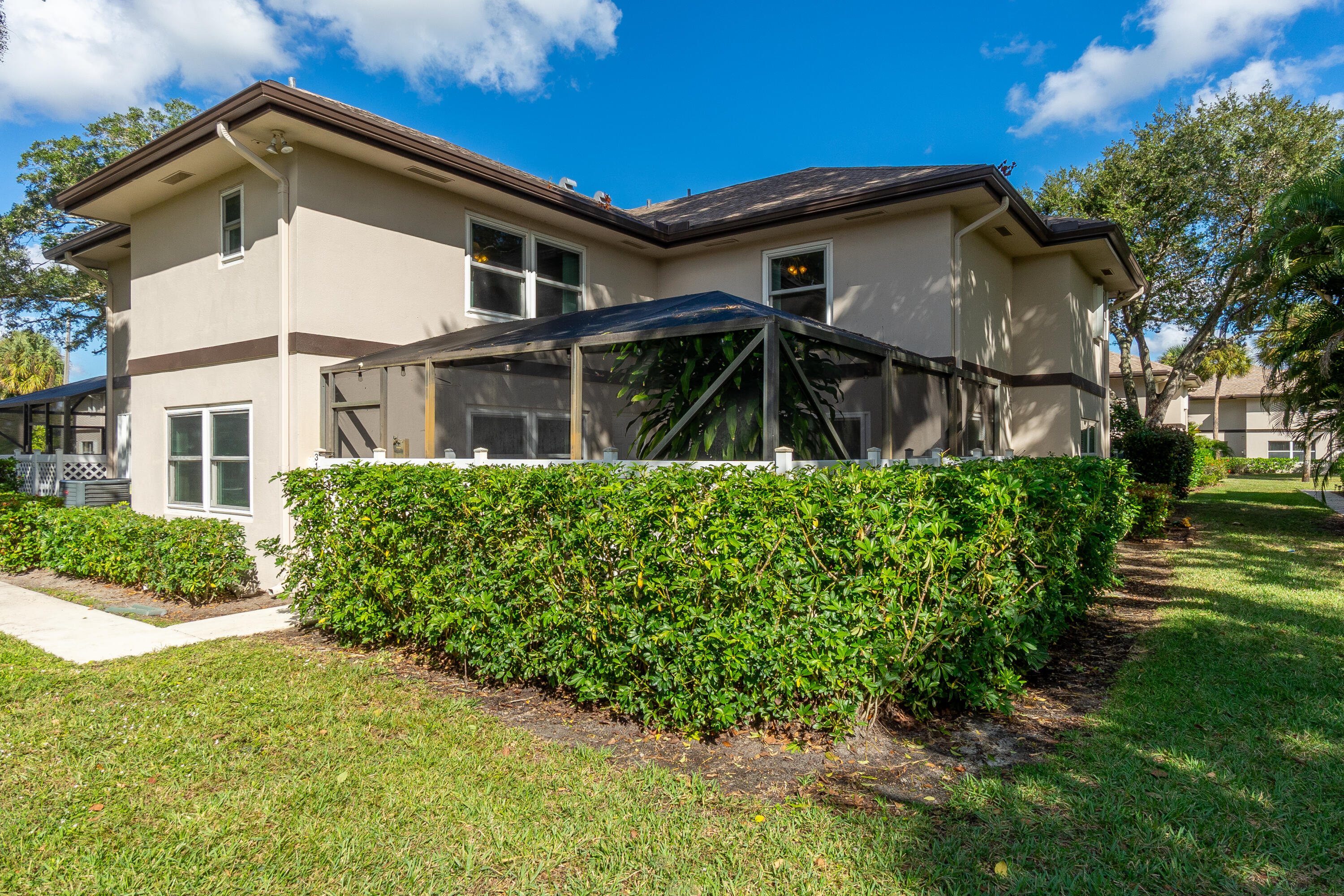 Beautifully upgraded townhome—this residence stands out with features others simply don't offer. Featuring IMPACT hurricane windows & sliders (estimated $30K+ value) for storm protection and peace of mind. Enjoy a premium screened-in lanai (estimated $15K+ value) with ideal southeast exposure—morning sun without harsh afternoon heat. Concrete attic adds durability and valuable storage. Remodeled kitchen with cherry cabinetry, granite countertops, and tile backsplash. Bright, open layout with dual en-suite bedrooms. Located toward the back of the community for added quiet and privacy. Steps to pool, close to shopping, dining, parks & schools.