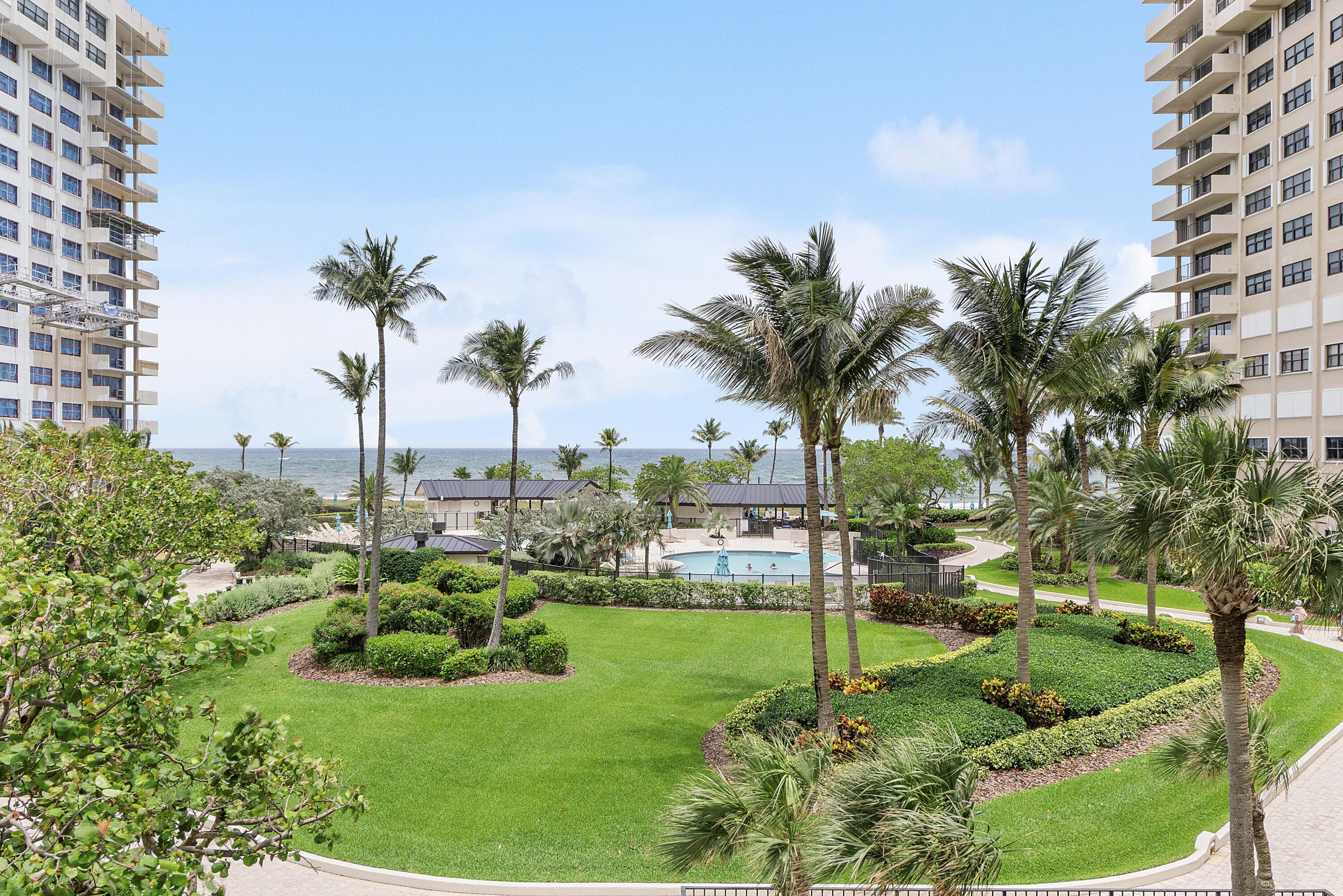 Astounding rarely available corner unit, offers the ultimate ocean front lifestyle. This 1,900 sq ft beachfront condo offers stunning ocean views and a spacious balcony where you can enjoy the sunrise and ocean breeze. The kitchen boasts stainless steel appliances, blue macaubas countertops, and contemporary cabinetry, complemented by matte grey tile throughout unit. The large primary suite features a custom walk-in closet, a private retreat bathroom with a soaking tub and separate shower. The second bedroom opens to a balcony, to enjoy sunset views. Additional features include impact windows and doors, a washer/dryer in unit, and two garage parking spaces conveniently located near the semi-private elevator lobby. Many resort like amenities   Amenities: 14 acres of deep beachfront, Three pools, three open-air kitchens cabanas, gas grills, beachfront charcoal grills, eight tennis courts, herb gardens, putting green, two dog parks, sauna, gym, EV charging stations, and a car wash area. Conveniently situated close to shops and restaurants. Great for investors It can be rented after purchase
