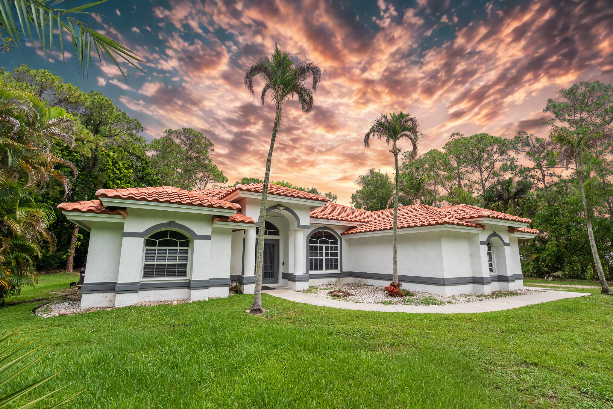 Experience the perfect blend of privacy, comfort, and Florida living in this beautifully updated Gated estate situated on 1.15 acres. This spacious 3-bedroom, 2-bathroom single-family home features a thoughtfully renovated interior, including a modern kitchen, updated bathrooms, new flooring throughout, and a brand-new roof.Step outside to your own private backyard retreat, complete with a sparkling swimming pool and screened lanai, creating the ideal setting for relaxing, entertaining, or enjoying Florida's year-round sunshine. Additional highlights include a large garage, an oversized driveway with ample parking for multiple vehicles, and a desirable single-story layout. Annual lease preferred; seasonal rental inquiries are welcome. Pet-friendly, this exceptional rental offers both space and flexibility for a variety of lifestyles. Conveniently located just 1.8 miles from Publix (approximately a 5-minute drive), you'll enjoy easy access to shopping, dining, and everyday essentials.  Rarely does a property offer this combination of acreage, privacy, modern updates, and resort-style outdoor living. Don't miss the opportunity to make this unique residence your next home.