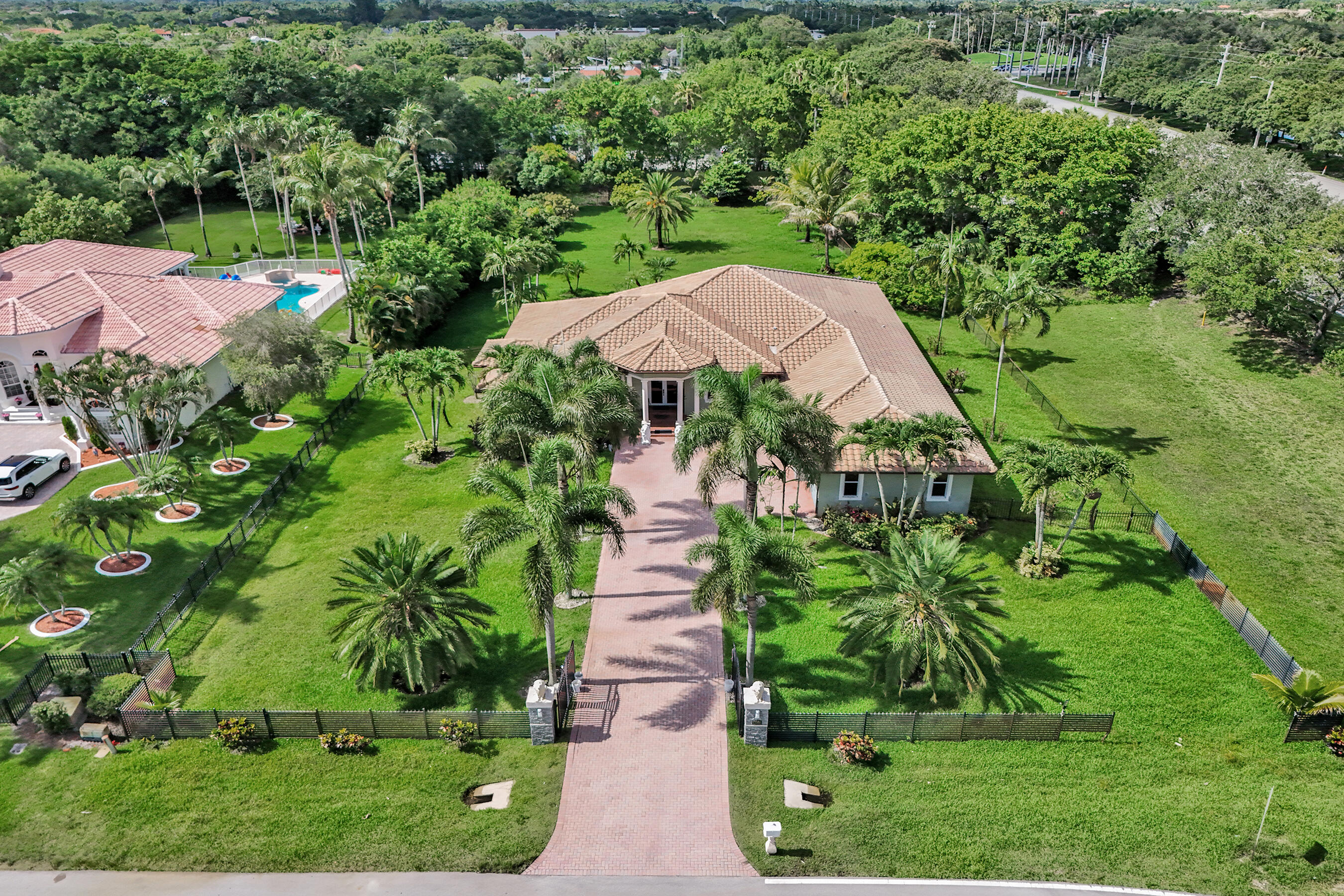 Rare opportunity in the highly coveted Plantation Acres. Built in 2011, this modern single-story estate features 5 bedrooms, 4 bathrooms, plus a huge 3-car garage. Priced to sell, the true value-add is the massive, ultra-deep lot—a blank canvas with unmatched depth, perfect for creating a premier resort-style pool oasis, guest house, or mega-entertainment zone. Modern 2011 construction means lower insurance costs and newer systems, saving you thousands compared to older area homes. Bring your design touches and instantly unlock massive equity in one of Plantation's best acreage communities. Will not last!