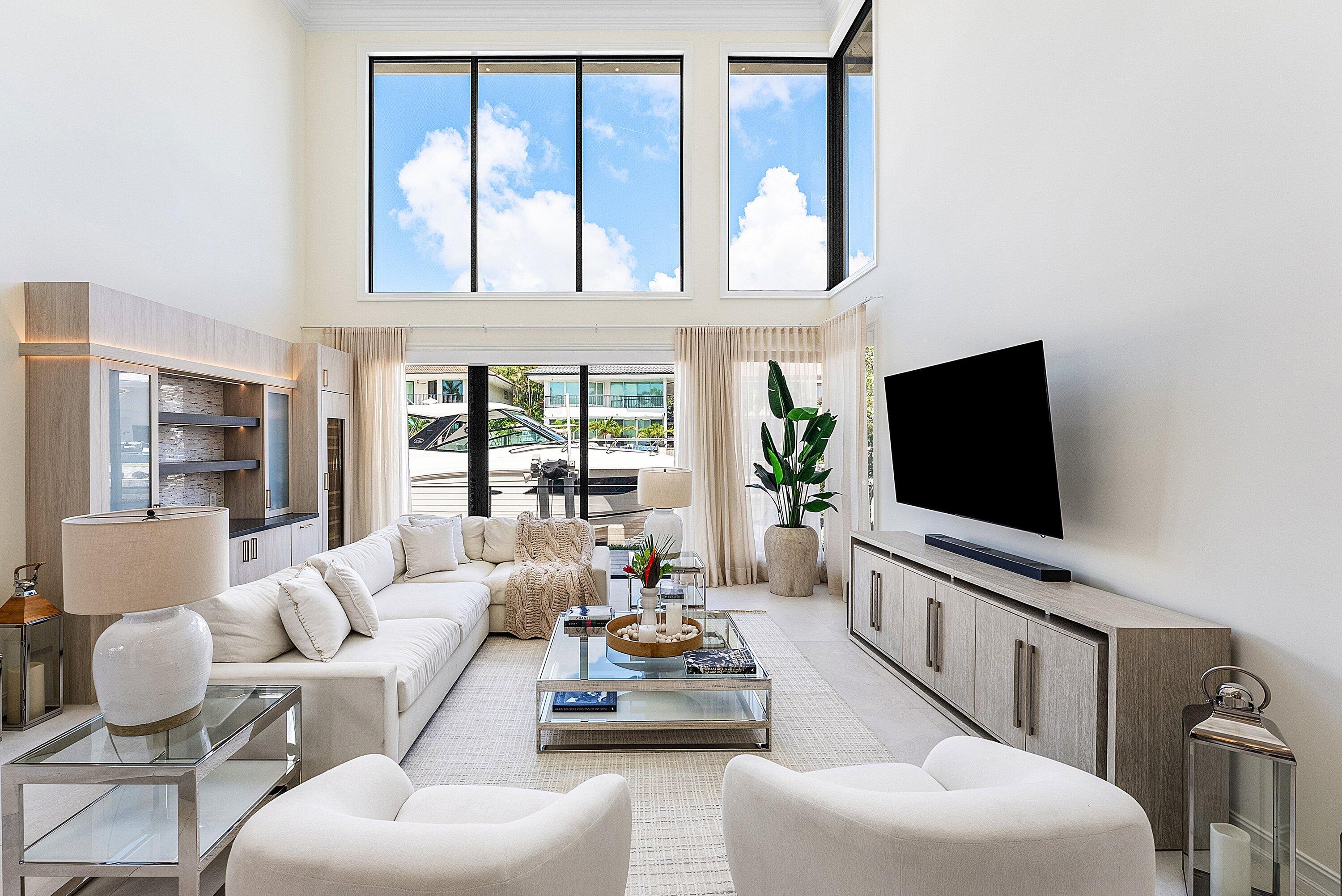 This Impeccably Renovated 5BDRM, 5.1BA Waterfront Residence Presents a Rare Opportunity to Own a Luxurious Waterfront Estate within one of Boca Raton's Most Prestigious Gated Enclaves. Every Detail has been Thoughtfully Designed to Balance Architectural Luxury and Presence.  The Residence Opens Seamlessly to Expansive Living and Dining Areas where Soaring Ceilings and Walls of Floor-to-Ceiling Windows Infuse the Interiors w/ Natural Light with Water Views from all Main Living Areas.  A Beautifully Appointed & Exceptionally Designed Kitchen supports Everyday Living and Elevated Entertaining. The Home's Intelligent Floorplan includes a Private Office, a Dedicated Movie Theater, and an Integrated Entertainment Bar, including a Wine Cooler & Ice Maker, Ideal for Effortless Hosting.  Through a Private Courtyard Entry, the Residence Reveals a Resort-Style Outdoor Sanctuary Featuring a Heated Saltwater Pool and a Fully Equipped Summer Kitchen. A Separate Guest House with a Full Bath and Mini-Fridge Provides Exceptional Flexibility and Privacy for Visiting Friends.  Hurricane-Rated Impact Glass and a Full-House Generator Ensure Year-Round Peace of Mind. This rare turn-key opportunity comes move-in ready, with furniture and boat negotiable allowing you to step into the complete Florida lifestyle from Day 1. Must have a valid Drivers License at Gate for access.