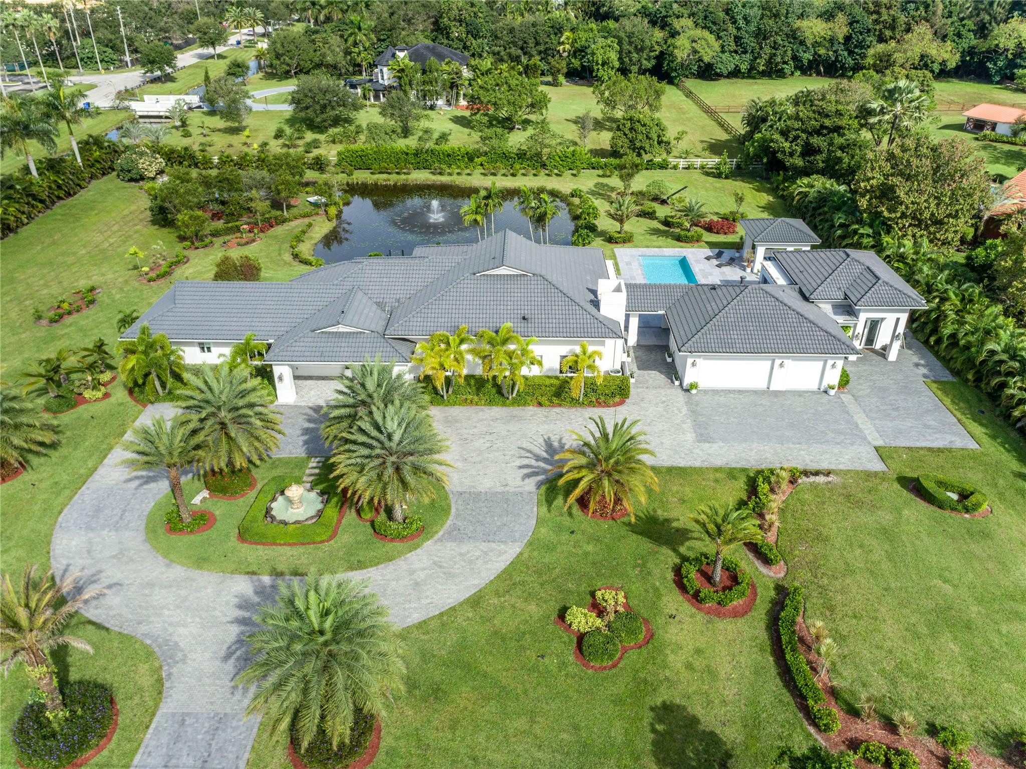 ***YOUR PRIVATE OASIS IN SUNSHINE RANCHES AWAITS!!!*** THIS LUSH 2.3-AC ESTATE OFFERS A TOTAL OF 6,200 SF HOME THAT BLENDS RUSTIC CHARM W/MODERN ELEGANCE. VAULTED CEILINGS,ITALIAN PORCELAIN FLRS&SUNLIT OPEN LAYOUT. GOURMET KITCHEN W/HAND-PAINTED ITALIAN TILE, QUARTZ COUNTERS, CUSTOM CABINETRY&TOP-LEVEL APPLIANCES. PICTURESQUE GROUNDS W/TROPICAL STORYBOOK SETTING. ENJOY OUTDOOR LIVING W/COV'D TERRACES, BUILT-IN BBQ, ARGENTINIAN GRILL, BRICK PIZZA OVEN&FULL SUMMER KITCHEN. RESORT-STYLE SALTWATER POOL&DET GUEST HOUSE COMPLETE THIS EXCEPTIONAL PROPERTY. IMPACT WINDOWS &DOORS,DESIGNER LIGHTING, CUSTOM CLOSETS,LUXURY FINISHES THROUGHOUT. GATED ENTRY,LONG PRIVATE DRIVEWAY&ROOM TO ADD TENNIS OR PICKLEBALL COURTS. ENJOY THE BEST OF LUXURY,PRIVACY&TRANQUILITY IN ONE OF MOST SOUGHT-AFTER COMMUNITIES.