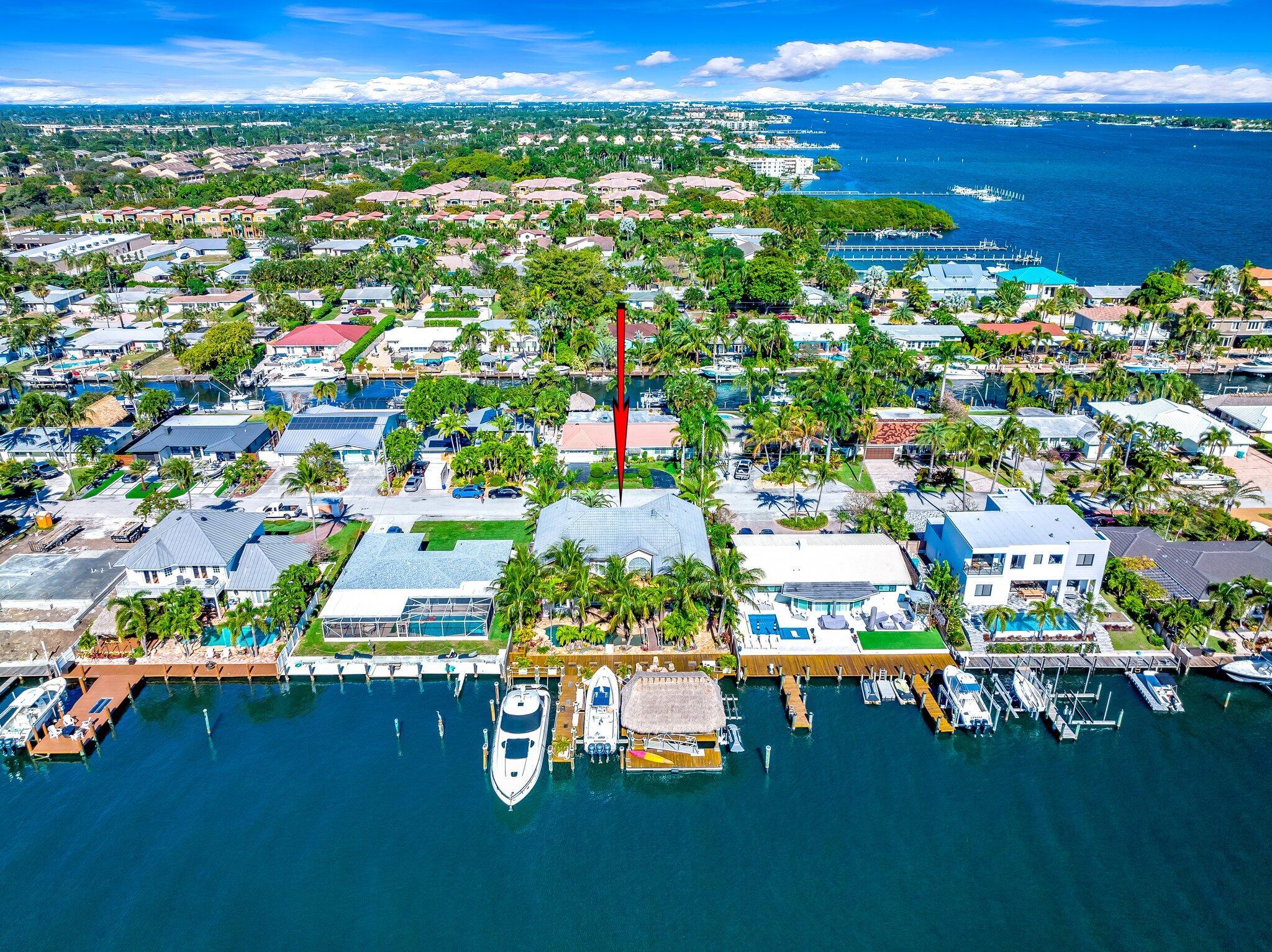 This boaters paradise in Coquina Cove is situated on the Boynton Spillway (or C16 Canal) with deep water and 150'+ width, situated on a cul-de-sac with sunny Southern exposure in the back yard! With 5 bedrooms + office and 4 full baths, this estate is the perfect retreat for lovers of the salt life. The outdoor oasis was designed to enjoy waterfront living at it's finest, complete with summer kitchen, tiki bar, dockage for multiple vessels plus jet skis. The unique pool and dock will impress the most discerning buyer. Originally built in 2003 and now completing a full 2022/2023 renovation with designer finishes throughout. Both the interior and exterior finishes have been reimagined for the ultimate waterfront paradise. Just minutes from the ocean on the intracoastal waterways. A must see!