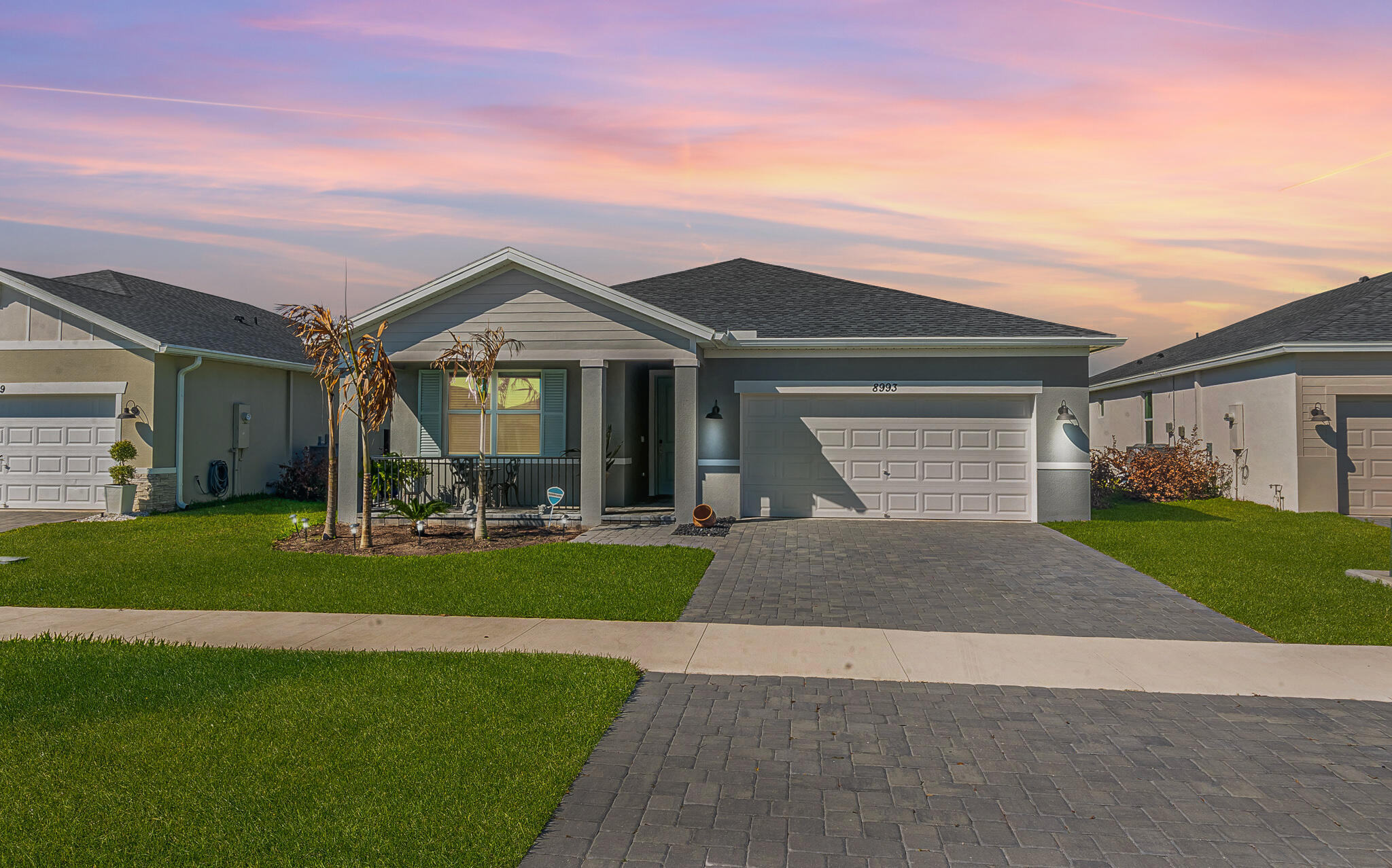 Experience the perfect blend of modern luxury and eco-friendly living in Azalea. This stunning 2024-built home features 4 spacious bedrooms, 3 full baths, and a state-of-the-art Tesla whole-house solar system for ultimate energy efficiency.Situated on a prime lakefront lot, the exterior boasts a large, fully fenced yard and covered, screened lanai—perfect for enjoying serene water views. The interior is designed to impress with wood-look tile throughout most living areas, elegant 8' panel doors, and complete impact glass for peace of mind. The kitchen  featuring quartz countertops, stainless steel appliances, a large island, and a convenient walk-in pantry. With no CDD fees and a low monthly HOA, this home offers incredible value in a fantastic location.