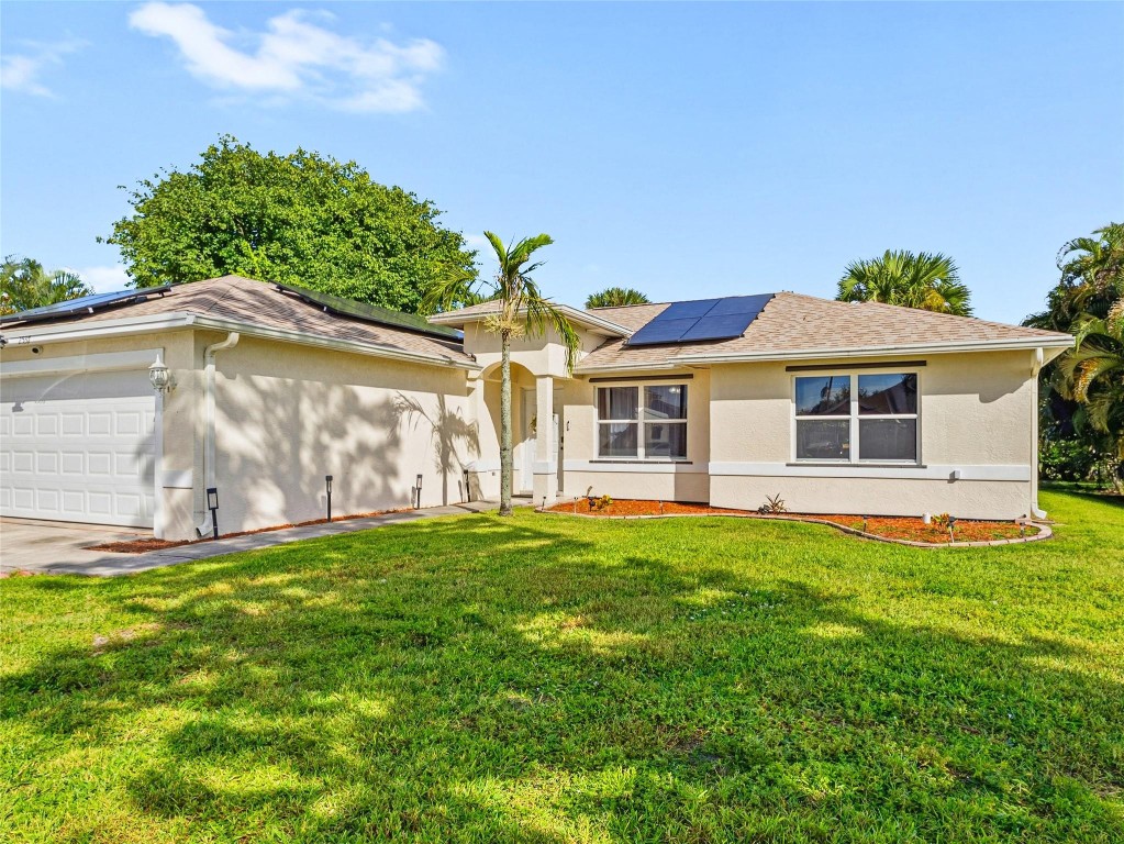 *Pending Short Sale Approval! A Lovely 3/2 single family home, nearby dining, shopping & access to I-95. Features a spacious 2-car garage, vaulted ceilings, updated ceiling fans, & durable tile throughout. Updated kitchen, soft-close cabinets with dovetail drawers, granite countertops & sleek stainless steel appliances. Generously sized bedrooms and a large utility room for added convenience. Elegant French doors open up to a covered porch and leads out to a large backyard, offering plenty of space for kids to play or to add a future pool, oversized driveway, new impact garage door, updated roof & AC, both 2023, water heater 2026, and energy-efficient solar panels. County water, septic system, and no HOA fees, home offers comfort and freedom. A lovely place to call home Agent must accompany buyer.