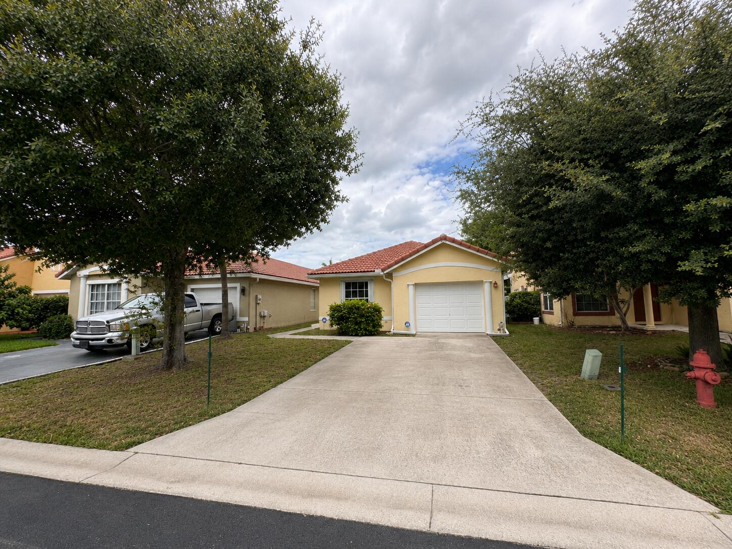 A rare opportunity to finally own a Single Family House with a garage, low HOA fees, and for under $400K. AC is 2024. Water heater is 2020. Roof is original, but no leaks or concerns.  Very private backyard that can easily be fully fenced. Accordion shutters on all openings besides the window above the front door. Home has gutters. 1 car garage and 2 car driveway. Endless potentional inside with tall vaulted ceilings in both the main living area and master bedroom. Kitchen has potential to open up and has large pantry and dedicated dining area.  Master bedroom has walk-in closet. Master bathroom has double sink vanity and walk-in shower. Private laundry room is very desirable. 2nd bathroom has tub / shower combo.  *Carpets throughout either need to be cleaned or need to be replaced.* HOA fees include maintenance to common areas, community pool, and playground.