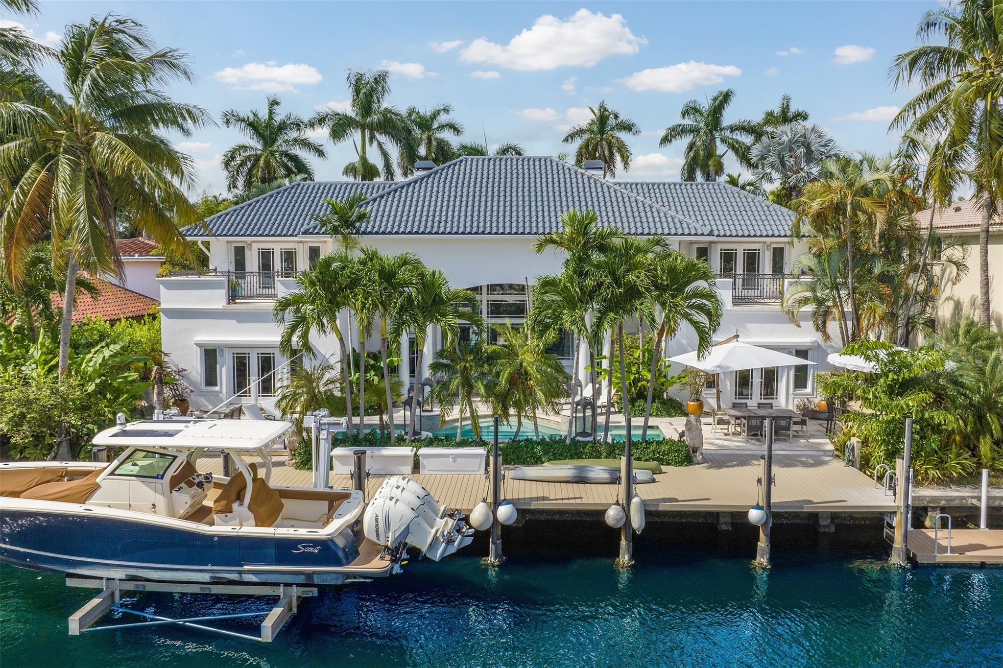 Preferred east-facing waterfront estate on one of Las Olas Isles' most prestigious streets. Set on a prized 12,000-square-foot lot with 100 feet of deep-water dockage, this timeless residence offers tranquil wide-water views, elegant coastal architecture, and refined living just moments from the beach and Las Olas Boulevard. Spanning nearly 5,800 square feet, the home features expansive entertaining spaces, a first-floor primary suite with private loggia, multiple courtyards and terraces, pool, gazebo bar, fireplace, and three-car garage. A rare opportunity combining premier location, exceptional waterfront, and enduring long-term value. Beaches, fine dining and shopping are minutes away. Royal Palm Drive is favored for its higher elevation, wider, deeper lots and underground utilities. Here is an opportunity supported by both the intrinsic qualities of the property and recent market activity within the Las Olas Isles. This property offers a highly desirable 12,000-square-foot lot with 100 feet of waterfront on a premium street characterized by consistent lot widths and larger surrounding homes an important factor that reinforces long-term value. In this market, waterfront land alone typically commands approximately $35,000 to $50,000 per linear foot, placing significant underlying value on the site itself. Additionally, the residence encompasses 5,752 square feet of interior living space, aligning well with expectations for a property of this scale, where homes generally trade in the range of $1,200 to $1,500 per square foot. The benefit is a combination of a well-proportioned home, strong land value, and a superior location.  Premium east-facing waterfront exposure 100 feet of deep-water dockage Large 12,000 SF lot Prestigious street within Las Olas Isles High-quality scale at nearly 5,800 SF Timeless architecture instead of speculative modern construction Proximity to beach and Las Olas