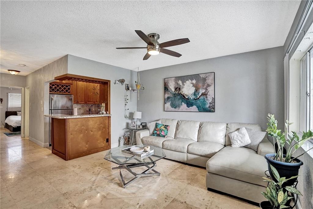 Location, Location. Situated right off US1 & Commercial Blvd. This adorable 1 Bed, 1 Bath apartment is move in ready and perfect for a 'bachelor(ette) pad' or vacation home. Just a short bike ride (1.5 miles) to the great beach town- Lauderdale by the Sea, or a quick drive to downtown Fort Lauderdale and the airport. Located on the 2ndfloor, with a patio area overlooking the pool and gardens. Marble floors throughout. Updated kitchen features granite counters, stainless appliances, oak cabinetry and tile backsplash. Beautiful spa-like bathroom with stand up shower. Great closet space. Brand new mini splits installed & work great to keep condo cool & electric bill low. Additional storage unit included. Hurricane shutters. Low HOA. Montclair Gardens community is charming and well maintained.
