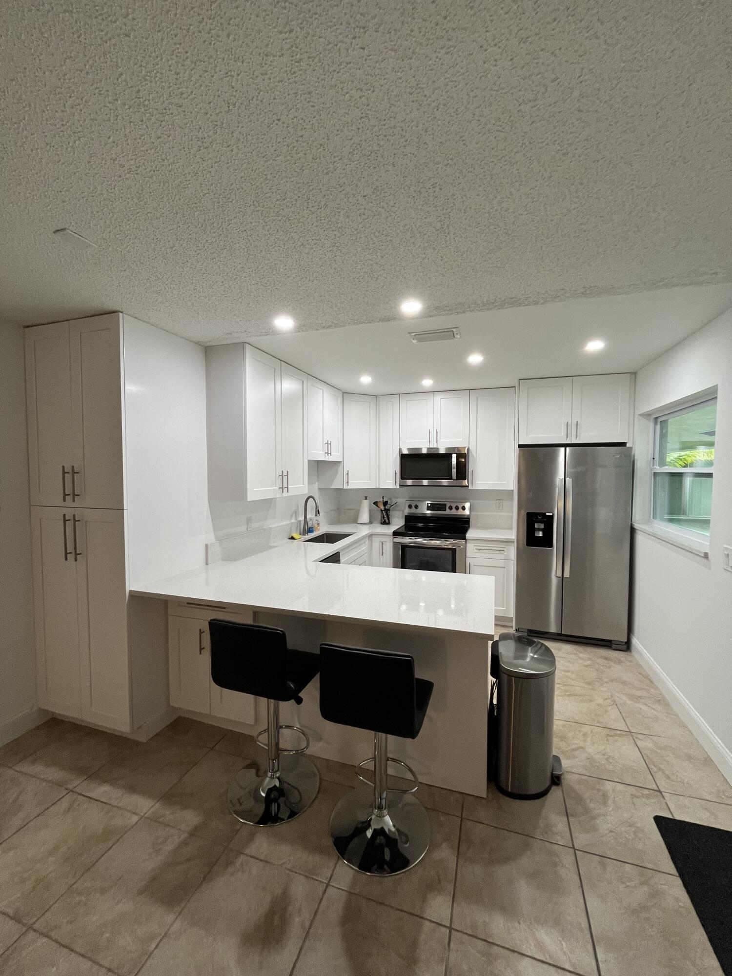COMPLETELY UPDATED 2/1 - KITCHEN WITH WHITE CABINETRY GRANITE AND STAINLESS APPLIANCES. TILE FLOORING. NEW IMPACT WINDOWS. STACKABLE WASHER / DRYER IN UNIT. AVAILABLE AS A PACKAGE WITH UNITS 1967, 1971 AND 1983. LOCATED 1 MILE FROM JUNO BEACH PARK AND MINUTES FROM SHOPPING DINING ENTERTAINMENT AND HIGHWAYS.