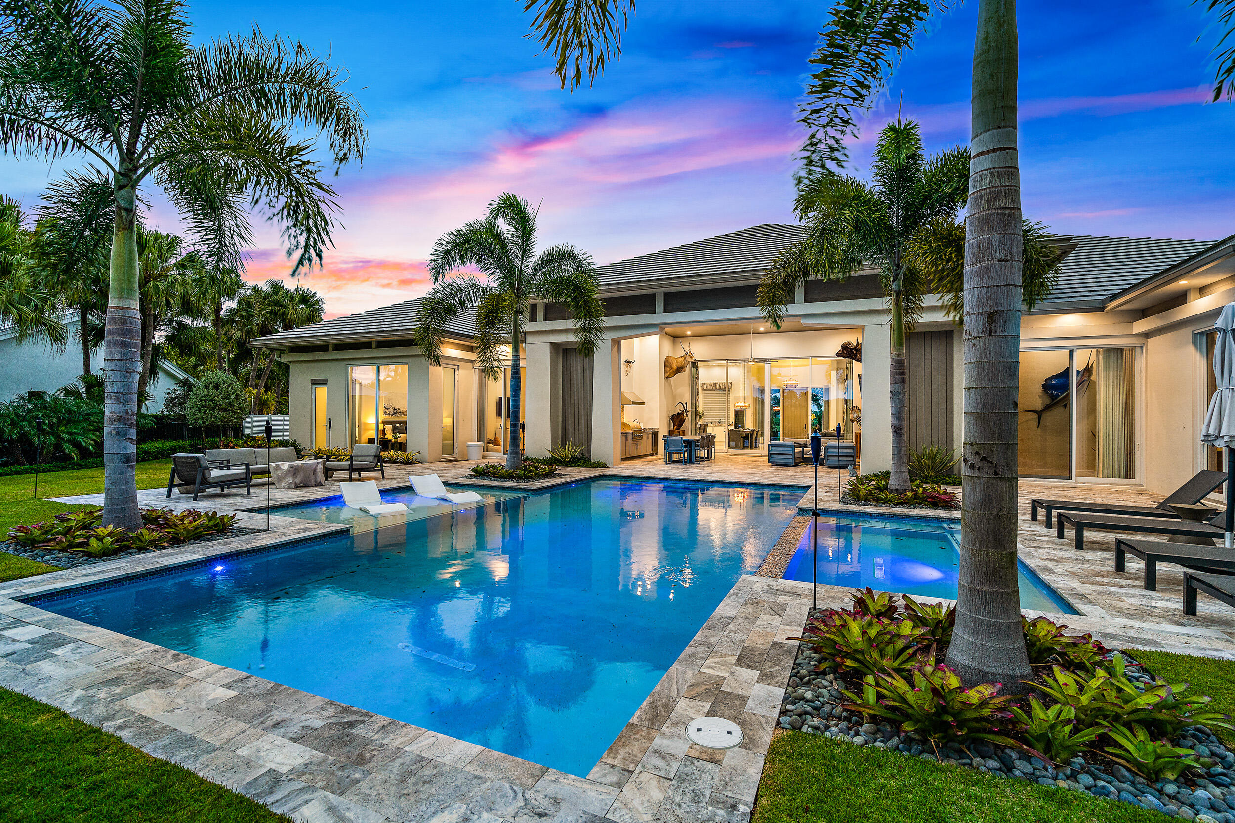 Newly built in 2020, this stunning modern / transitional styled home is sure to go fast! Situated on an oversized lot in the prestigious Admirals Cove, the backyard provides for plenty of outdoor entertaining space with a built in summer kitchen, phantom screens and fireplace.  The pool and lounge areas will make you feel like you've been transported to a tropical paradise.   Inside, the true chef's kitchen will inspire you to create culinary delights.  The kitchen is open to the spacious dining area and great room.   There are 4 bedrooms, each with private baths and one half bathroom as well as a work/study room.    In the master suite the luxurious bathroom and the separate oversized his and her closets will be sure to impress.  Modern elegance perfected.