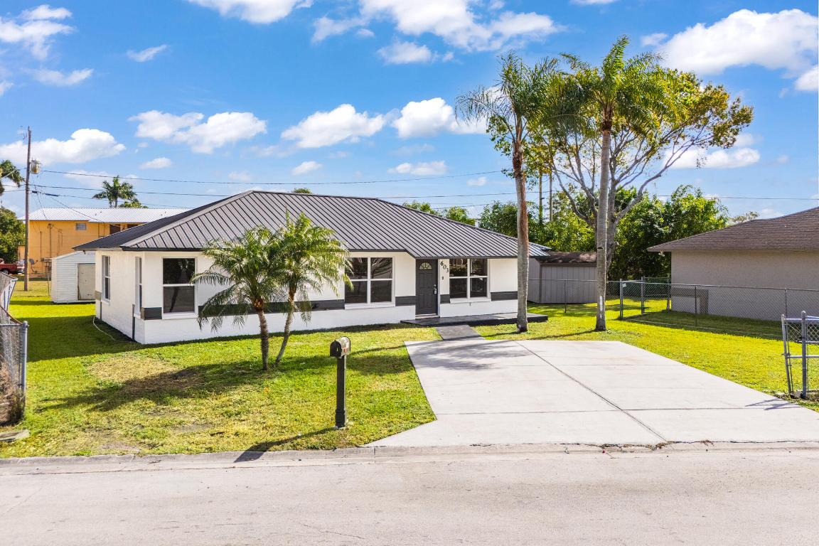 JUST REDUCED - BEST VALUE IN BELLE GLADE  Priced to Sell. This fully renovated home features a brand-new kitchen with quartz countertops and a quartz island, updated bathrooms, new luxury flooring, modern lighting, and all-new Samsung appliances, all designed for today's lifestyle.  The open, modern layout offers a bright, functional living space ideal for everyday living and entertaining. Major upgrades include a brand-new roof, providing long-term peace of mind.  Located in a great area, the home includes a large backyard with a shed, perfect for storage, outdoor living, or future use.  A true move-in ready home—schedule your showing today.