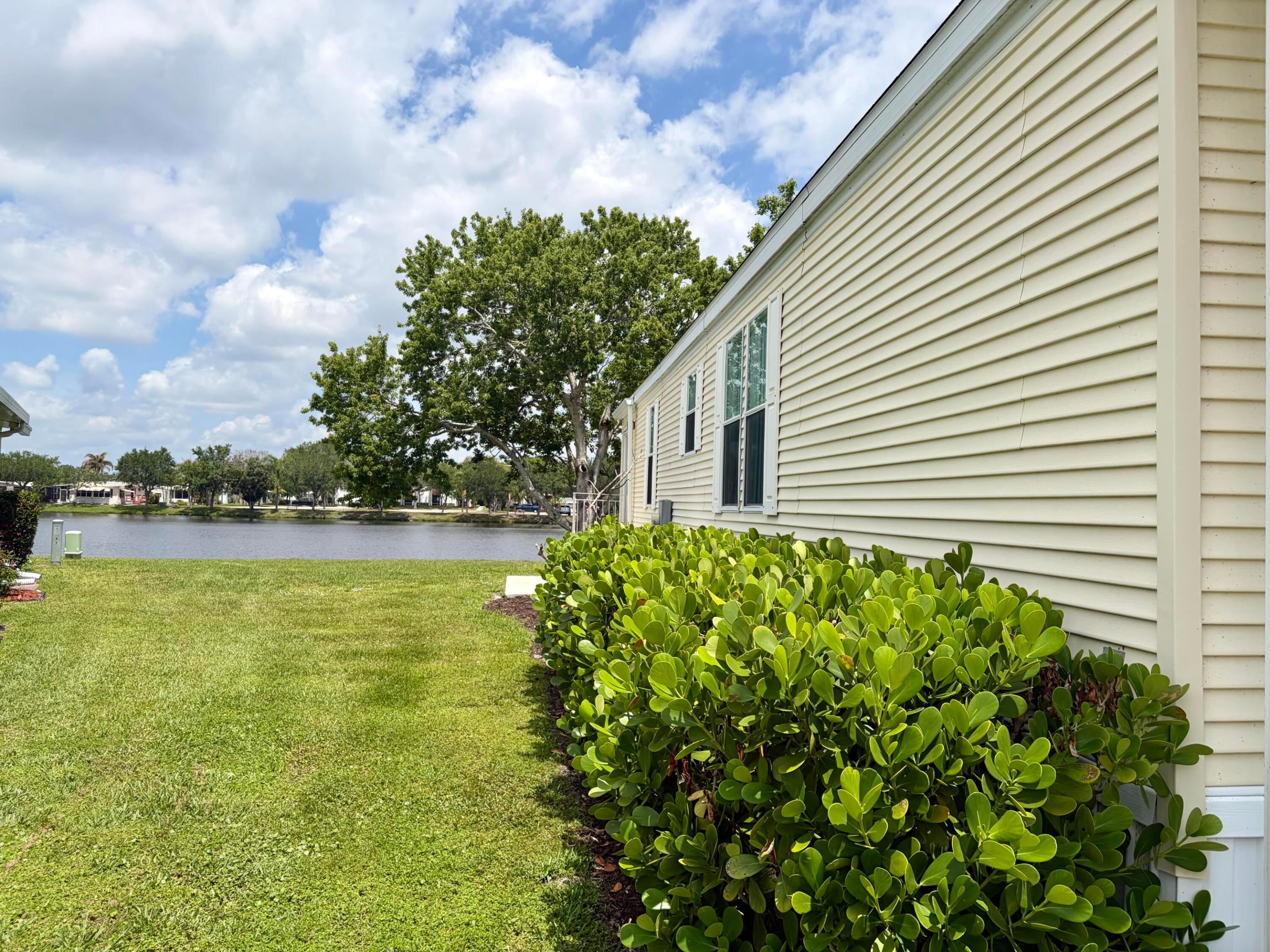 DRASTIC PRICE REDUCTION! Back on market. Pet Friendly lake lot walking distannce to the active culbhouse with pool, tennis, pickleball and numerous activities in this great 55+ community! Offered fully furnished and fully updated as shown with indoor laundry. There us a boat launch with access to Saint Lucie River ad to the intercoastal. Great fishing and ever changing tranquil sunsets> This 2006 Palm Harbor model will not disapoint with new central air 2024, vaulted ceilings and great lighting including the skylights in both bathrooms. Sitting on leased land, will require residency approval from Spanish Lakes 55+ community that we will walk you through. Please call ME as soon as possible as this home will go fast at this reduced price! Let's get you scheduled for a viewing and become the  new happy homeowner of this beauty with great relaxing views and lot's of  windows, larger equipped kitchen, remodeled baths and comfortable bedrooms await! CALL for OPENHOUSE SCHEDULES.