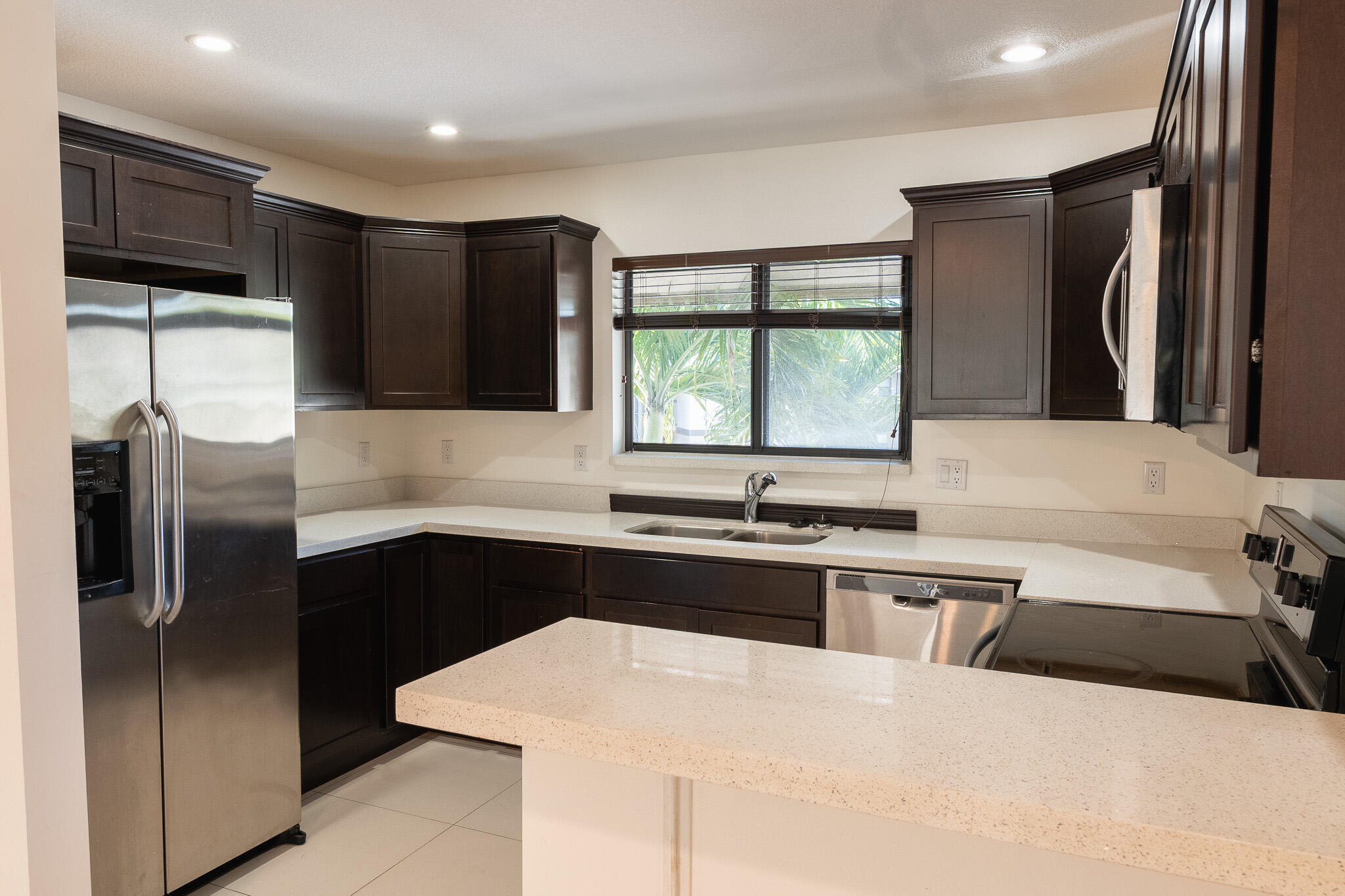 Beautifully updated 3-bedroom, 2-bath condo located in the heart of Wellington! This move-in-ready home features elegant porcelain flooring throughout, modern quartz countertops in both the kitchen and bathrooms, and a bright open layout designed for comfortable living. Nestled in a quiet and well-maintained community, this property offers the perfect blend of convenience and lifestyle. Enjoy being within walking distance to the village kids' park and community pool, while also being just minutes from top-rated restaurants, shopping, grocery stores, and everyday essentials. Excellent location close to schools, entertainment, and major roadways. Spacious, stylish, and centrally located — this one is a must-see and will not last long!