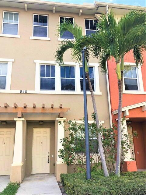 Great 2/2.5 townhome with den/office just steps to gym & pool. Recently installed plank flooring throughout. Large kitchen with 42'' cabinets, stainless steel appliances and granite counters. Newer washer/dryer stack. Attached 1 car garage with storage areas & additional driveway parking. 5 minutes from downtown West Palm, I-95, and PBI airport. Walk across the street to the new Palm Beach Outlet Shops, Whole Foods, Target, and multiple restaurants. Community amenities include 24hr manned gate w/ nightly roving patrol, HUGE lakeside pool, recently renovated gym and lakeside jogging track. Monthly rent includes cable & internet service with wi-fi, water, sewer, and trash removal. Vacant & move-in ready.