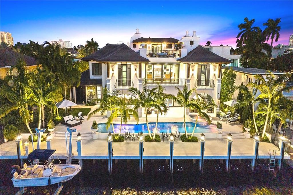 BESPOKE GRANDEUR!! 2020 CUSTOM!! 5 bedroom / 7.5 bath / 3 level residence. Well-conceived layout - epic two story foyer opens to living & formal dining rms, gorgeous gourmet kitchen w/spectacular island, breakfast rm, butler’s pantry, laundry, cabana bath, office w/cylindrical aquarium, wet bar & VIP guest suite are on first level; Ascend grand staircase to enter primary suite w/waterfront views, dual spa-like baths, boutique sized closets, safe rooms & balcony; Also residing on this level are 3 ensuite guest rms, & 2nd laundry. Elevator & exterior staircase gain access to 3 level family fun media rm w/full bath & lux sun deck w/2nd summer kitchen! Resort-like salt pool/spa, 100’ dock, 21K lift, summer kitchen, EV Charging; A/C Garages w/5 car availability, +golf cart bay, 100K Generator.