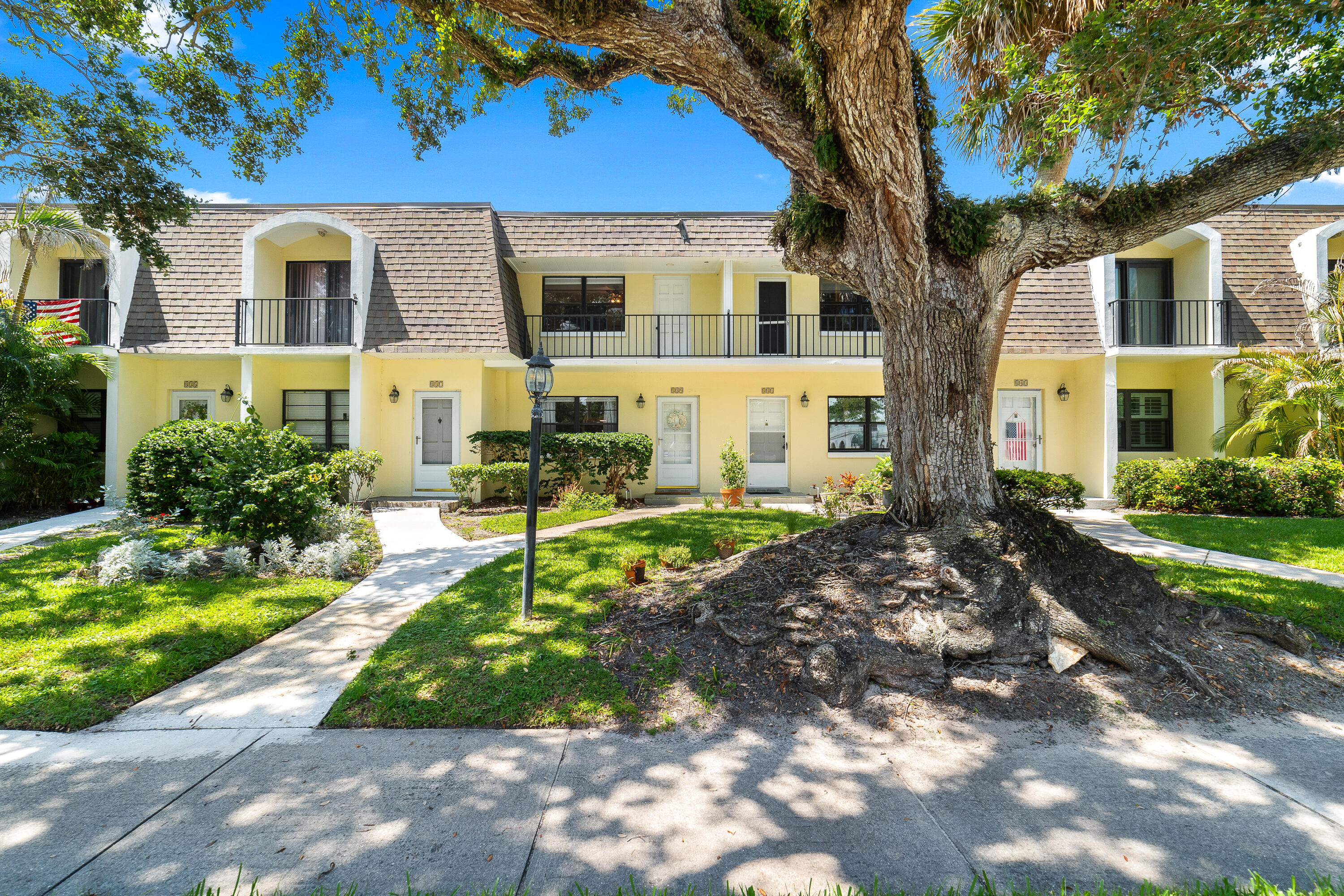 Rare opportunity to own a beautifully updated two-story townhome-style condominium east of A1A, just blocks from Ocean Drive's shopping, dining, and beaches. This move-in-ready residence lives like a private home and features a desirable split-bedroom floor plan with two spacious upstairs bedrooms, each offering an ensuite bath and private balcony. The main level features a bright and inviting living area, a convenient half bath, and an in-unit laundry hookup. Recent improvements include an updated kitchen with stainless steel appliances, new marble countertops, modern lighting, renovated bathrooms (2023), and tile throughout main floor and luxury vinyl upstairs. A newer A/C system enhances year-round comfort and efficiency.  Enjoy outdoor living on the tranquil, partially screened rear patio. HOA maintenance includes water, grounds maintenance, building exterior upkeep, and roof maintenance, providing added convenience and value.