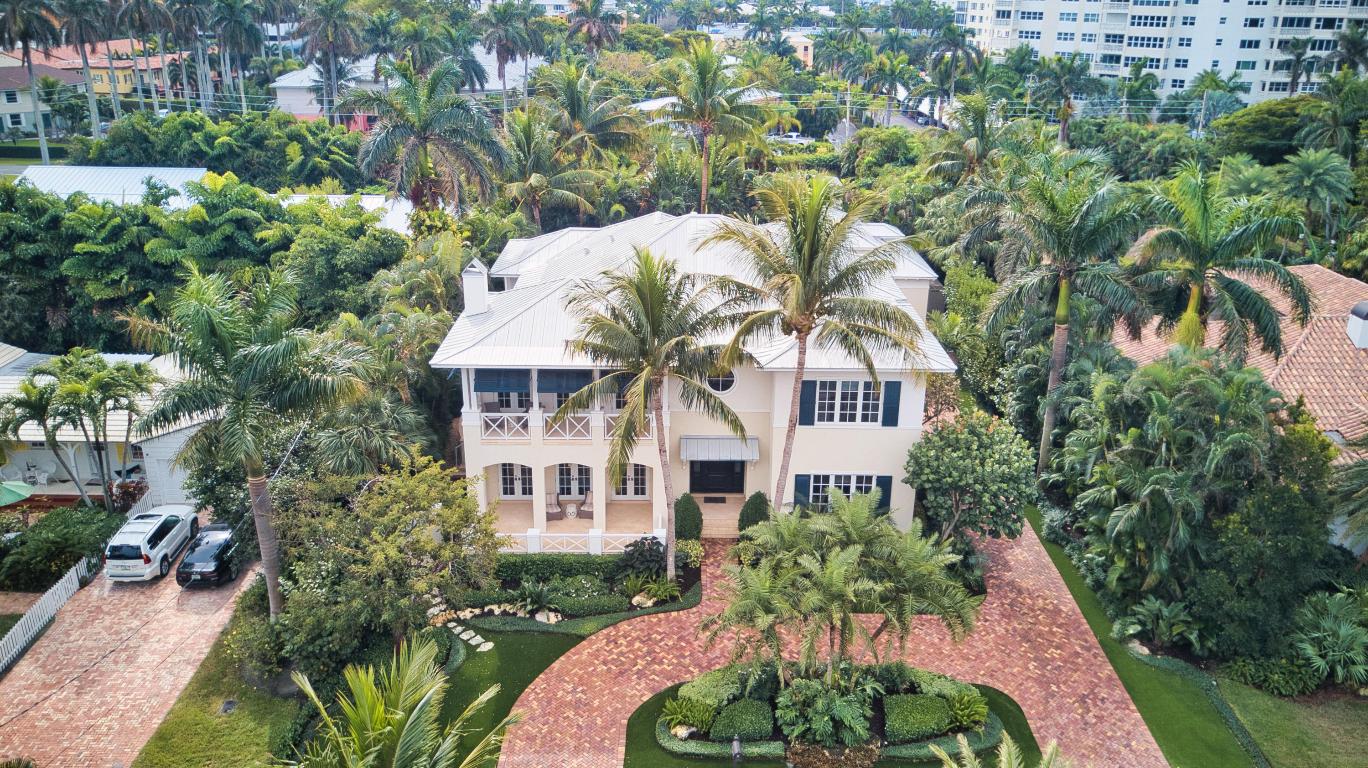 Welcome home to 1030 Basin Drive, a William Wiestma designed British West Indies masterpiece! This elegant Ocean Breeze estate has it all! Boasting nearly 6000 square feet, this pristine 2-story pool home with separate guest studio has 5-bedrooms, 5.2-baths and 85 feet of deep water with dockage/lift for a 40 foot boat and kayak safe launch. Impeccably maintained with impact glass, 3-car garage, whole home generator, elevator, covered loggia overlooking your backyard paradise, vaulted ceilings, metal roof, wine closet, butler pantry, balconies, hardwood floors, coffered ceilings & so much more! Ideally located close to the ocean, Atlantic Avenue, 3 international airports, and fine dining, shopping, culture, theater, art & more. Incredible location, unparalleled home! Come see for yourself!