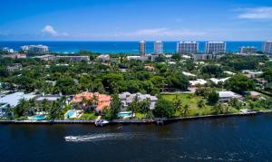Completely remodeled. Set in a canopy of Banyan trees, this beautiful Tuscan-inspired intracoastal estate was custom built by Addison Developers Dan Swanson of Palm Beach on an oversized lot with 135 ft of water frontage on the coveted Spanish River Road. A dramatic marble foyer with fountain steps down to a formal living room. A gallery leads to the formal dining room with butler's pantry and office/study. Chef's gourmet kitchen opens to a junior dining room and family room with English pub, wine room, and theater/media room. Also available furnished at $7,995,000.