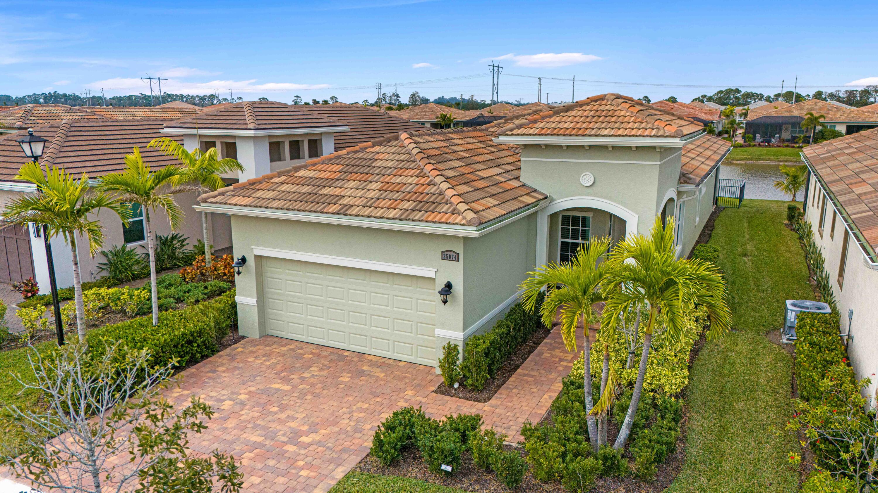 Waterfront 'Casita' Model in Verano PGA Village. Discover lakefront living in this well maintained 2 BR's, 2 BA's, plus large den/office & 2 car garage with epoxy flooring. Laundry room featuring cabinets and utility sink. Built with CBS construction,  Barrel tile roof, hurricane impact windows and doors. Volume ceilings & tile in main areas. The open kitchen is a chef's dream, showcasing quartz countertops, a glass backsplash, stainless steel appliances (new refrigerator), 42'' soft-close cabinets, a breakfast bar, island & pantry. The spacious master suite includes a walk-in closet, dual sinks and a seamless glass shower, while the split floor plan ensures privacy. Beautiful Tranquil lake views includes screen enclosed lanai & spacious fenced backyard. ONE YEAR HOME WARRANTY INCLUDED!! HOA includes: Recreation clubhouse Talavera, lawn care, exterior pest control, cable, high speed internet, alarm monitoring & manned gated security. PGA Verano is a resort style community with 27 pickle ball courts, tennis courts, fitness centers with state of the art equipment, indoor and outdoor pools, saunas, and dog park. Exceptional Talavera Social Club 19,000 sq ft offers something for everyone! There is a golf cart path to the PGA Golf Club which offers 3 Public Championship Golf Courses and Private Course (membership optional). Located minutes from Shopping, Restaurants, Activities, Entertainment & Even Home of the New York Mets Spring Training. Only 45 Minutes from Palm Beach Airport and a growing area. The Treasure Coast has beautiful Waterways for the Beach, Fishing & Boating. Due to the location of the Treasure Coast the Weather is delightful! Schedule your private showing today this gem won't last!
