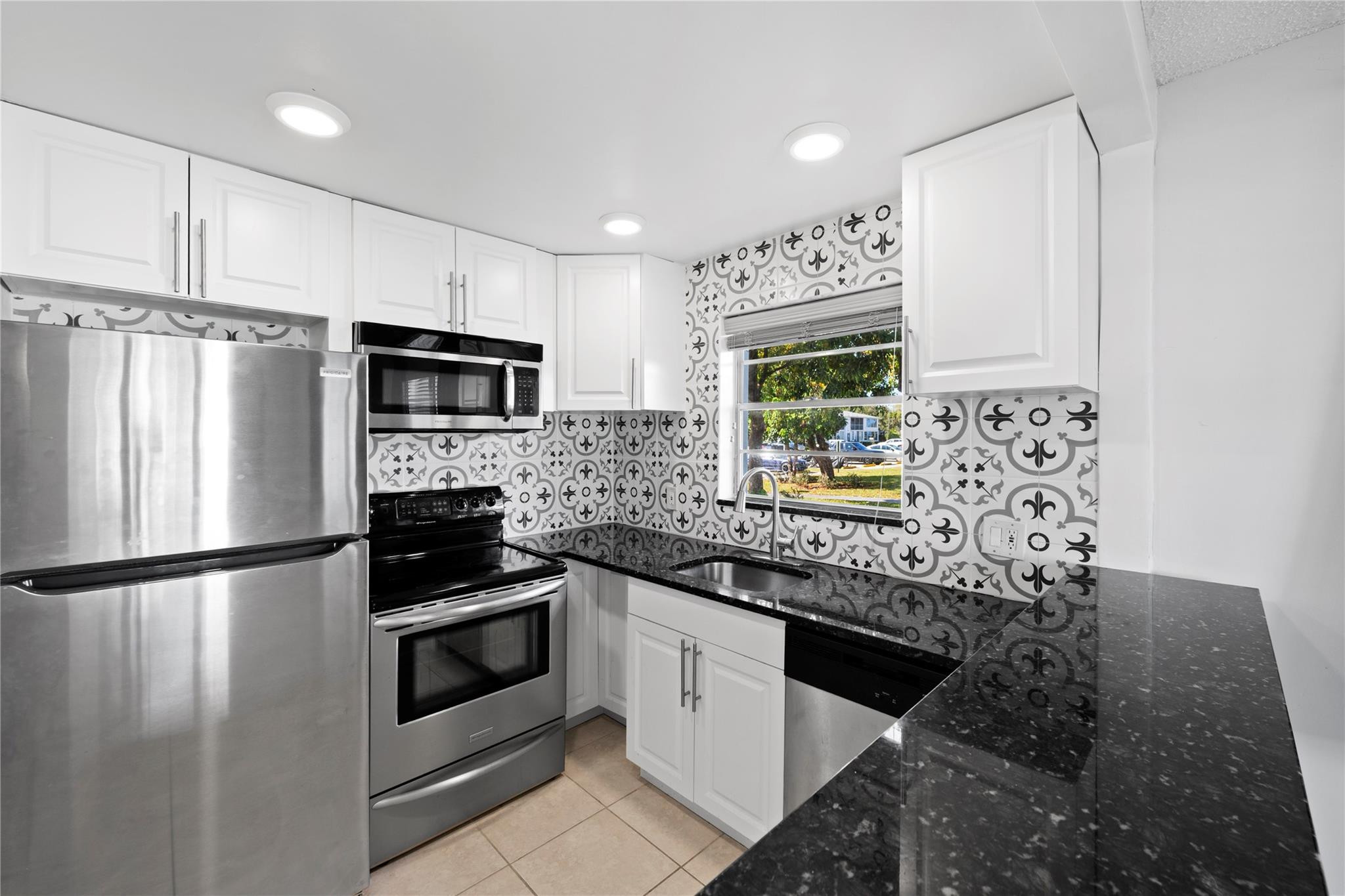 Spacious 1-bedroom, 1.5-bathroom condo conveniently located on the first floor in the gated 55+ community of Century Village. Situated near the beach, shopping, and dining, this residence offers both comfort and convenience. The condo features tile flooring throughout, a modern white kitchen with granite countertops, and stainless steel appliances. Enjoy your private screened in patio from your primary suite. The laundry room is conveniently located just steps from the unit. Community amenities include a clubhouse, swimming pool, tennis courts, courtesy bus service, and much more.