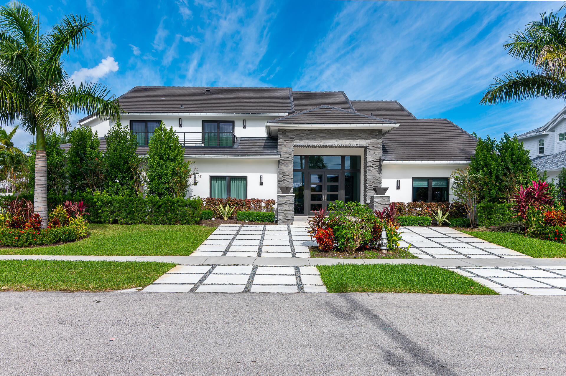 TURN KEY-TRULY BRING YOUR TOOTHBRUSH! Located in one of Boca Raton's most renowned Boating Communities, this impeccable, completely automated, 5 Bedroom estate encompasses almost 5400 SqFt of livable space. When arriving at this amazing home you will be greeted by gas-lit urns that illuminate the way to the grand foyer. This open floor plan includes a glass wine room with 180 bottle capacity, beverage cooler, and 2 wet bars. Impressive open gourmet kitchen with quartzite countertops and backsplash. Subzero/Wolf Appliances including gas cooktop, double ovens, a built-in coffee system, 2 dishwashers, and a butlers pantry complete the kitchen. A double-sided contemporary gas-burning fireplace enhances and separates the informal dining area and family room. Floor-to-ceiling sliding impact TRULY BRING YOUR TOOTHBRUSH! Located in one of Boca Raton's most renowned Boating Communities, this impeccable, completely automated, 5 Bedroom estate encompasses almost 5400 SqFt of livable space.  When arriving at this amazing home you will be greeted by gas-lit urns that illuminate the way to the grand foyer.  This open floor plan includes a glass wine room with 180 bottle
capacity, beverage cooler, and 2 wet bars. Impressive open gourmet kitchen with quartzite countertops and backsplash. Subzero/Wolf Appliances including gas cooktop,
double ovens, a built-in coffee system, 2 dishwashers, and a butlers pantry complete the kitchen. A double-sided contemporary gas-burning fireplace enhances and separates the informal dining area and family room.  Floor-to-ceiling sliding impact glass doors lead to the expansive outdoor entertaining area seamlessly combining indoor and outdoor living. Resort-style pool with sun shelf and backdrop of water feature with a dramatic gas fire backdrop.  Fully equipped summer kitchen directly outside of main kitchen area, outdoor shower, boat lift, and jet ski dock. A whole house generator with complete hurricane protection makes this home actually your fortress when needed. Laundry rooms on each floor. The second-floor sun deck gives complete privacy from neighbors as does the fence that encompasses the entire property.  Anti water leak system installed as well as a mosquito defense system and natural gas in the yard ready for hook up. A true must see