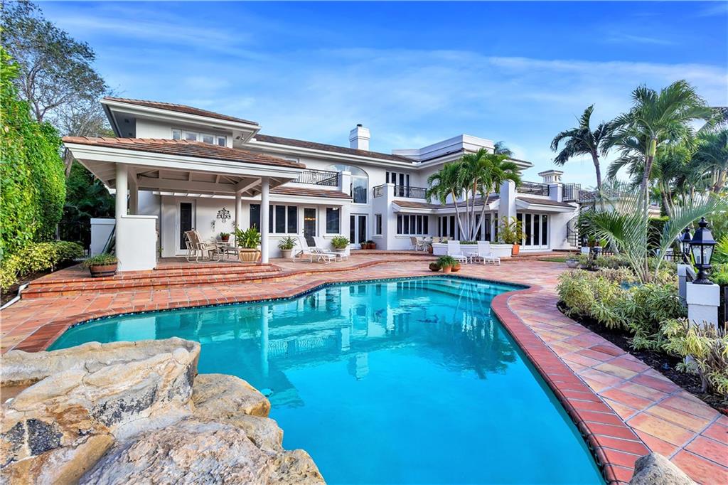 The most extraordinary value in a Royal Palm waterfront home. This home has an open floor plan of over 10,000 sq ft:7 large bedrooms(3 with balcony water views), redesigned kitchen and family room, large game room with bar and wine storage, media room, , and contemporary living room with soaring ceilings and marble floors, gas fireplace, and a bar with marble counters, wine cooler, and  custom cabinet storage space. This home has had only 1 owner, was completely rebuilt in 1998, and consistently updated over the years, including impact doors and windows. Recent upgrades include a new roof with slate style tiles under warranty,AC units (2015/2020), new 70 Ft dock with electric and water(2020), new paint on the entire house (2020), new specialty designed circular driveway and landscape-2020. This lovelyl home is situated on a large cul de sac lot (184 ft deep) with 110 ft on the water. The lot allows for beautiful curb appeal and a large back patio area with free form pool, separate heated Jacuzzi spa, and expansive water views. The new dock can accommodate a yacht of up to 100 feet.  Great for entertaining, and perfect for a large family.