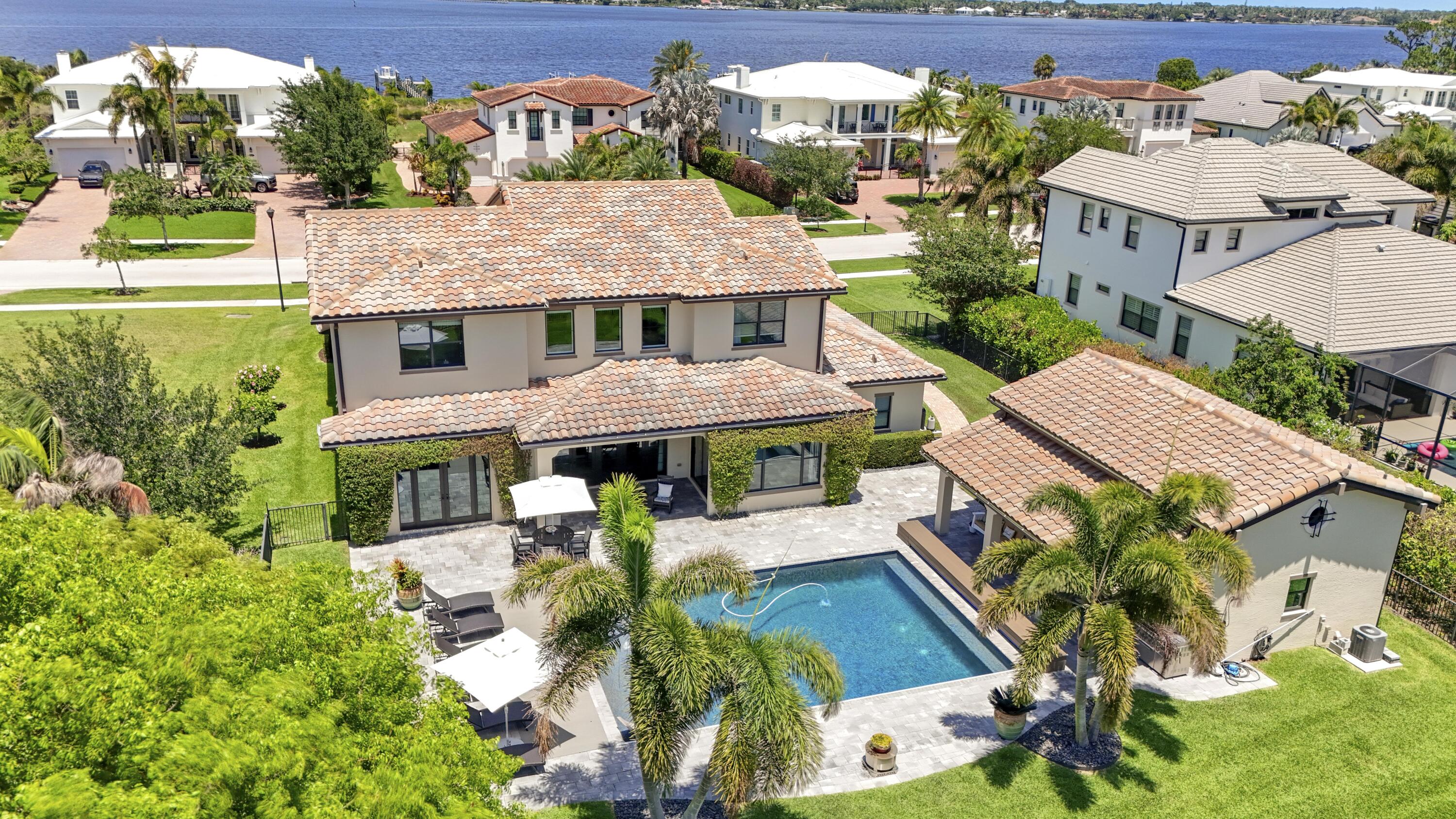 Enjoy the waterfront lifestyle—without the waterfront price.  Located in the highly sought-after gated Riverbend community, this exceptional estate includes access to a private community dock where you can launch kayaks, take in peaceful water views, and even temporarily moor your boat—an amenity that truly sets this home apart.  This 5-bedroom, 4.5-bath residence offers over 5,300 square feet of thoughtfully designed living space with an open floor plan ideal for everyday living and entertaining. Recent updates include new flooring, updated countertops, and a new gas cooktop, while an upstairs loft provides flexible space for a media room, office, or playroom.  The first-floor owner's suite is a private retreat with French doors opening to a backyard oasis featuring a saltwater pool and  covered patio—perfect for relaxing or hosting year-round. A standout feature is the detached guest house, complete with a full kitchen, bathroom, laundry, loft, and private living area—ideal for guests or added flexibility.  Conveniently located near I-95 and the Florida Turnpike, and just minutes from The Shoppes at Veranda Falls, Publix, and popular dining including Maggie McFly's, Kyle G's, and Casa Vincenzo, as well as NY Mets spring training.  A rare opportunity to own a spacious, flexible home with true lifestyle appeal in Riverbend. covered patio—perfect for relaxing or hosting year-round. A standout feature is the detached guest house, complete with a full kitchen, bathroom, laundry, loft, and private living area—ideal for guests or added flexibility.  Conveniently located near I-95 and the Florida Turnpike, and just minutes from The Shoppes at Veranda Falls, Publix, and popular dining including Maggie McFly's, Kyle G's, and Casa Vincenzo, as well as NY Mets spring training.  A rare opportunity to own a spacious, flexible home with true lifestyle appeal in Riverbend.