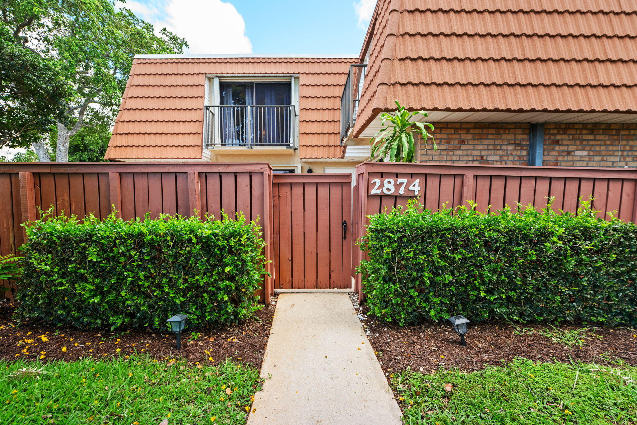 Meticulously maintained 2-bedroom, 2.5-bath corner townhome located in a quiet, well-kept community. Features include a beautifully updated primary bath, wood-look laminate flooring on the second floor, and a spacious living area with elegant stone flooring throughout the first floor. The kitchen offers oak cabinetry, granite countertops, and stainless steel appliances. A newer washer and dryer are conveniently located in the half bath, and the water heater is housed in the storage area under the stairs. Additional highlights include a security system, hurricane shutters, a large private courtyard, and a storage shed. Enjoy mature landscaping and beautifully maintained surroundings throughout the neighborhood. Owner occupied must call agent for access 24 hour notice.