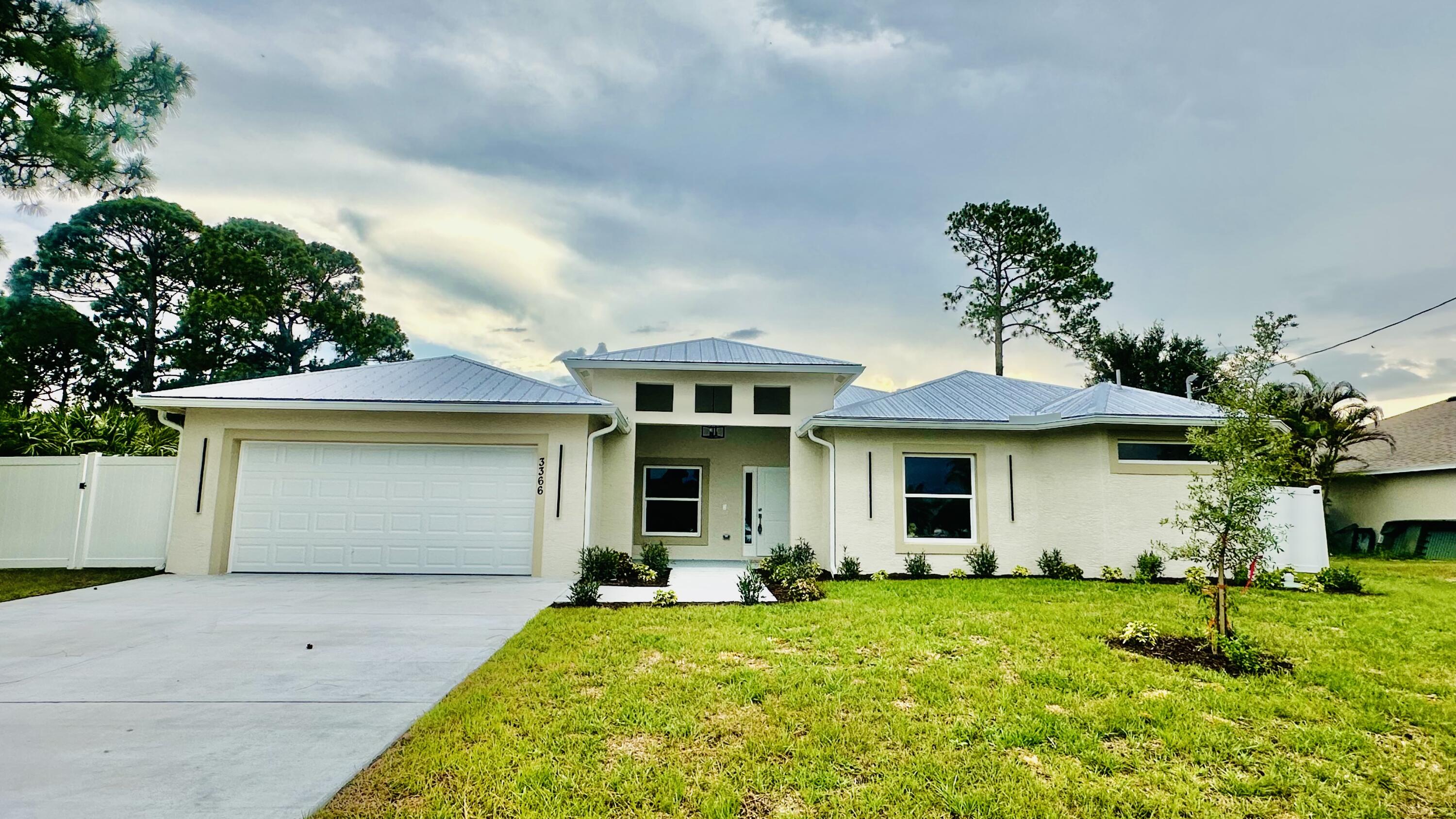 Brand-New 2026 Construction! No HOA. Enjoy breathtaking Florida sunsets and birdwatching from this beautiful 5-bedroom, 3-bath home overlooking O.L. Peacock Sr. Park & Lake. Conveniently located just minutes from Tradition, I-95, the Turnpike, shopping, dining, and hospitals. Features include a private office, den/family room, impact windows and doors, metal roof, fully fenced yard, 42-inch cabinets, granite countertops, stainless steel appliances, crown molding, and 32" x 32" porcelain tile throughout the main living areas. The spacious primary suite offers dual walk-in closets, a designer shower, and a freestanding tub. Move-in ready! Photos are of a previously sold model and may not reflect actual finishes. Associate is related to Seller.