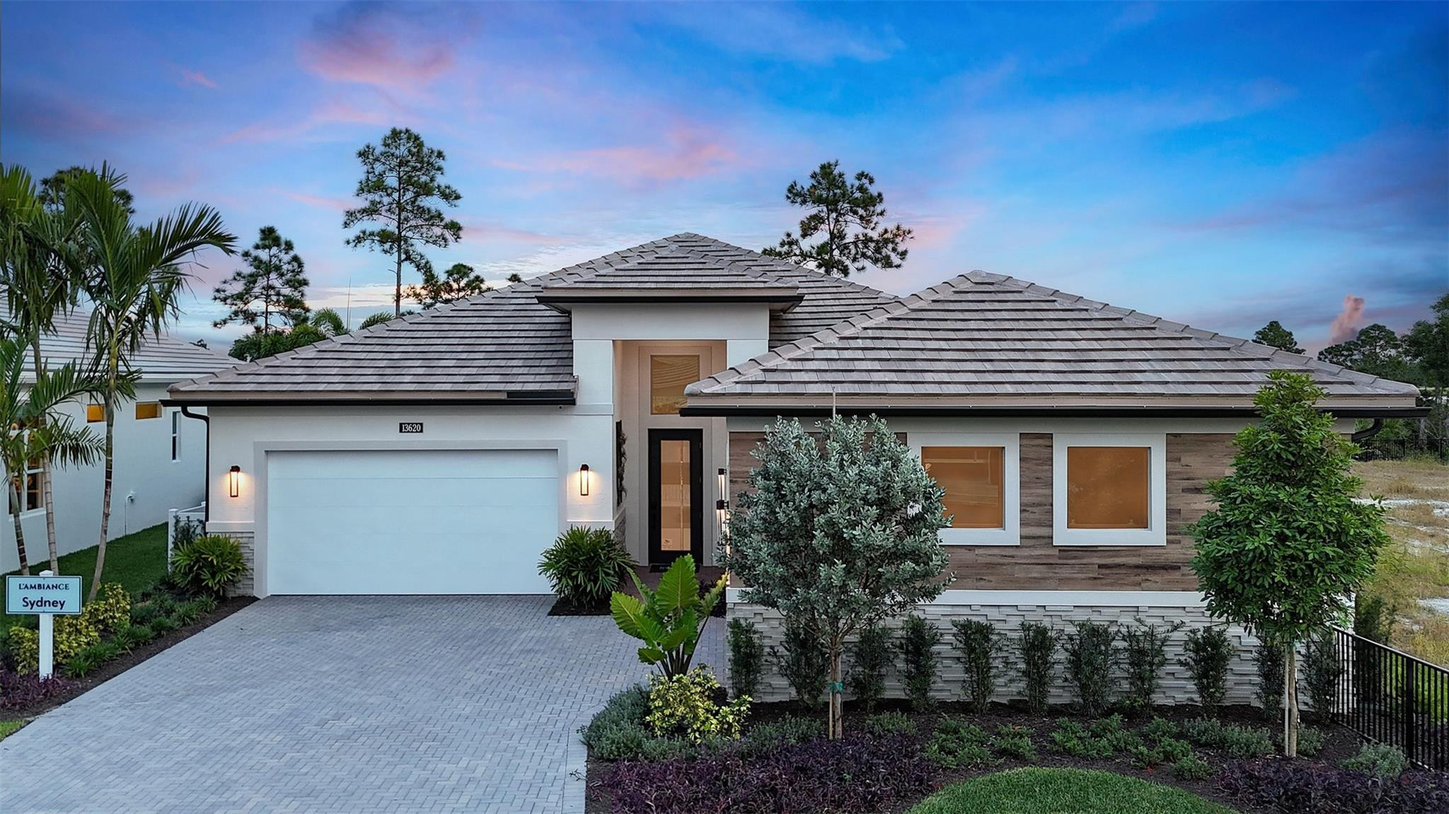 **NEW CONSTRUCTION**Fully Furnished, Decorated Sydney Model for sale. This professionally designed and decorated builders' model is being offered for sale with everything you see included. A custom pool overlooking a preserve view, within the gated community of L'Ambiance. This Sydney model, built by Kolter Homes has custom trim work and lighting throughout the home. A built-in closet and built-in pantry, complete this 3-bedroom, 3.5 bathroom, 4-car garage home. The lanai is accessed through a 16' wide slider to a built-in outdoor summer kitchen and a custom pool. The owner's bathroom includes the upgraded deluxe extended shower option, and the great room has an added 74'' electric fireplace.