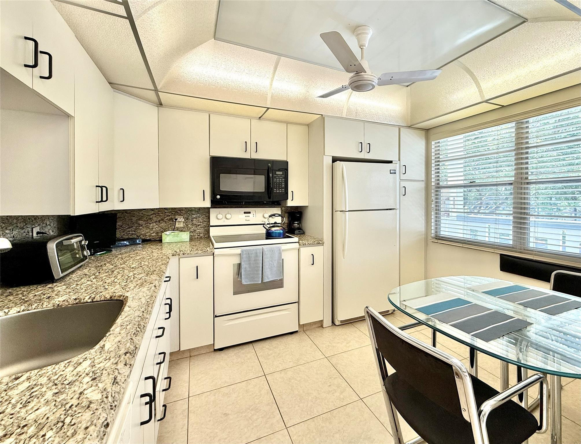 ACTIVE 55+ community! Bright 2nd floor home w/pool view. Receive rental income until JAN 14th ‘27 when lease expires. Updated kitchen with granite countertops, enclosed patio accessible from primary bedroom and living room, walk-in closet in spacious primary bedroom, ensuite with double sinks, tub/shower combo plus walk-in shower in 2nd bedroom. Newer AC and water heater. Privacy hallway between living and bedrooms. Enjoy BBQ and pool area. Live your best life with golf, theater, fitness center, clubs, heated pools and so much more! All included in condo fee PLUS water, HOTWIRE CABLE, free laundry machines on each floor, trash removal and interior pest control! Excellent location near shopping and restaurants in a secure community with a 24-hour manned gate at an affordable price.