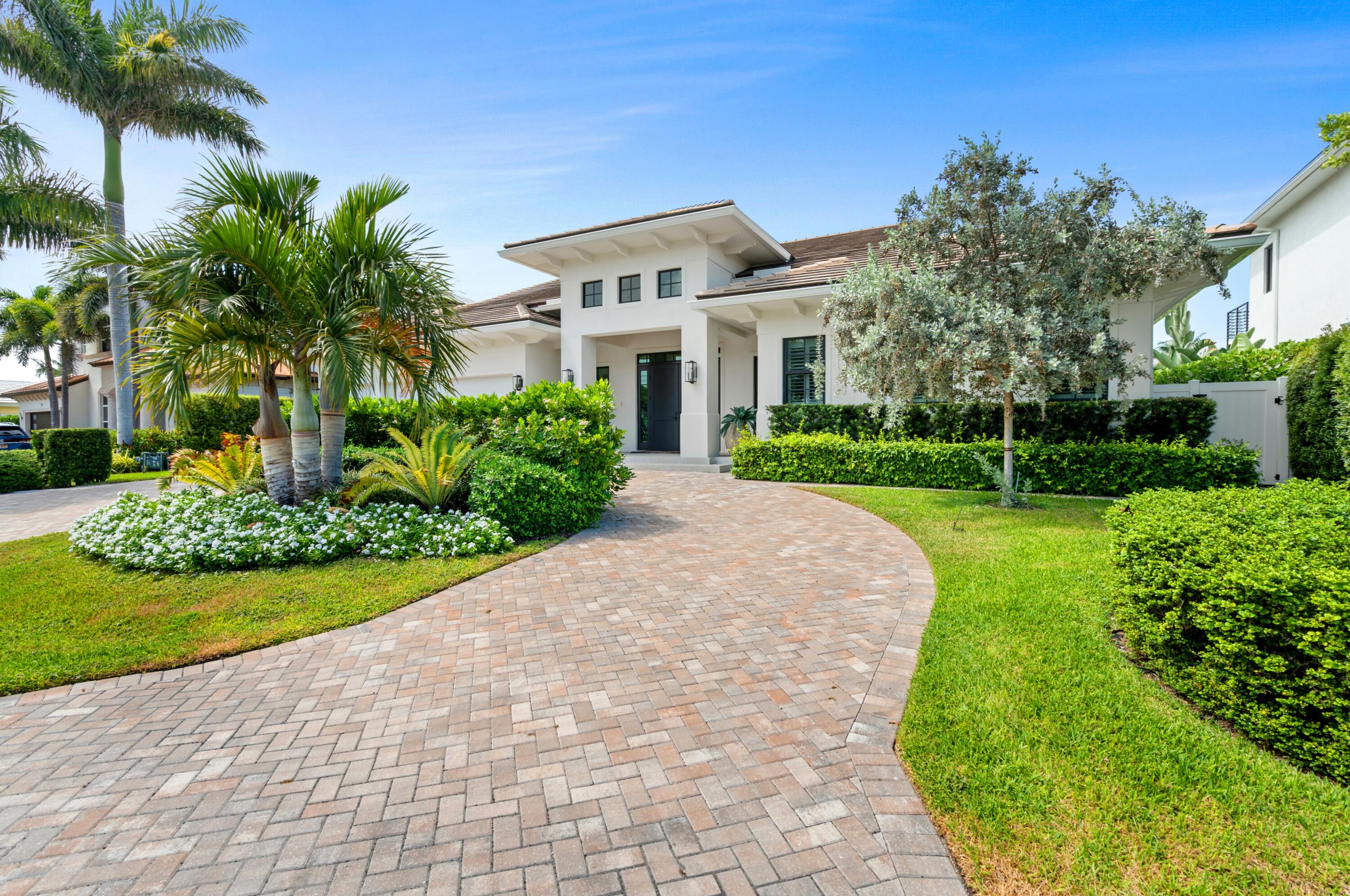 Chic 2022-built estate in desirable Tropic Isle, Delray Beach, offers 90 feet on a canal with a dock off the Intracoastal. Interior details include a chic living room with a linear gas fireplace and full bar, a stunning glass-encased wine display, gourmet cook-island kitchen with Thermador appliances, a luxurious pool-view primary suite, two offices and a poolside loggia and summer kitchen. LOCATION: 

925 Allamanda Drive, Delray Beach, Florida. Tropic Isle, a desirable yachting community fronting the Intracoastal Waterway with a yacht harbor and deep-draft canals, is located just minutes from the ocean beach at Atlantic Dunes Park and famous Atlantic Avenue in vibrant downtown Delray Beach, known for its shopping, dining, and entertainment venues.

PROPERTY: 
 
Creating a welcoming sense of arrival, a brick-paved drive circles around a verdant oasis to the front portico and the three-car garage, while with 90 feet on a canal off Intracoastal Waterway with a 70-foot composite dock, residents enjoy boating and water sports. In the tropically landscaped backyard, which is hedged for privacy, the loggia and fully equipped summer kitchen, with auto shades and featuring a tongue-and-grove ceiling, flow out to the stone-paver patio centered on the sun-splashed pool with a spa and fountain sprays. A fun additional perk is the putting green.

RESIDENCE: 
Built in 2022 in collaboration with Vinicio Fernandez Architect and Beach Front Builders Construction, this three-bedroom residence, encompassing 4,170± total square feet, combines chic sophisticated interiors with captivating outdoor settings, perfect for seamless indoor/outdoor living and entertaining. A double-door entry from the portico opens to a striking living room, crowned by a coffered ceiling and centered on a sleek gas linear fireplace flanked by built-in cabinetry, while a fully appointed bar with seating adds both function and flair. Defining the transition between the living room and dining room, a partial wall serves as a showpiece, with its artistic floor-to-ceiling glass-encased wine display and built-in cabinetry for books or curated collections. From the dining room, a bank of sliding doors opens to the poolside loggia and summer kitchen. The adjoining cook-island kitchen, also with direct access to the loggia, is appointed with custom cabinetry, quartz countertops, and professional-grade Thermador appliances that include a chef-style gas stove with ovens, dishwasher, refrigerator/freezer, wall microwave oven, and warming drawer. The primary suite, with sliding glass doors to the pool, comprises two custom-fitted walk-in closets, a linen closet, and a spa-like bathroom, with dual sinks, quartz countertops, marble flooring, a sleek walk-in shower with a detachable handheld sprayer, soaking tub, and separate water closet. Of the two guest bedroom suites, one is privately positioned directly off the foyer with its own dedicated entry. Completing the layout are two offices with built-in cabinetry, laundry room and powder room. Amenities include impact-rated windows and doors, luxury vinyl flooring, natural gas accommodation, generator hookup, flat-tile roof, two carrier air-conditioners, LED lighting, full-house water purifier and a Sonos sound system. A sanctuary that invites both relaxation and festive moments, every detail of this bespoke residence speaks to modern elegance and comfort

The information herein is deemed reliable and subject to errors, omissions or changes without notice.  The information has been derived from architectural plans or county records. Buyer should verify all measurements

DISCLAIMER: Information published or otherwise provided by the listing company and its representatives including but not limited to prices, measurements, square footages, lot sizes, calculations, statistics, and videos are deemed reliable but are not guaranteed and are subject to errors, omissions or changes without notice. All such information should be independently verified by any prospective purchaser or seller. Parties should perform their own due diligence to verify such information prior to a sale or listing. Listing company expressly disclaims any warranty or representation regarding such information. Prices published are either list price, sold price, and/or last asking price. The listing company participates in the Multiple Listing Service and IDX. The properties published as listed and sold are not necessarily exclusive to listing company and may be listed or have sold with other members of the Multiple Listing Service. Transactions where listing company represented both buyers and sellers are calculated as two sales. "No payments made until title passes" Some affiliations may not be applicable to certain geographic areas. If your property is currently listed with another broker, please disregard any solicitation for services. Information published or otherwise provided by seller, listing company or its representatives is deemed reliable but are not guaranteed and subject to errors, omissions, or changes without notice. Copyright 2025 by the listing company. All Rights Reserved.