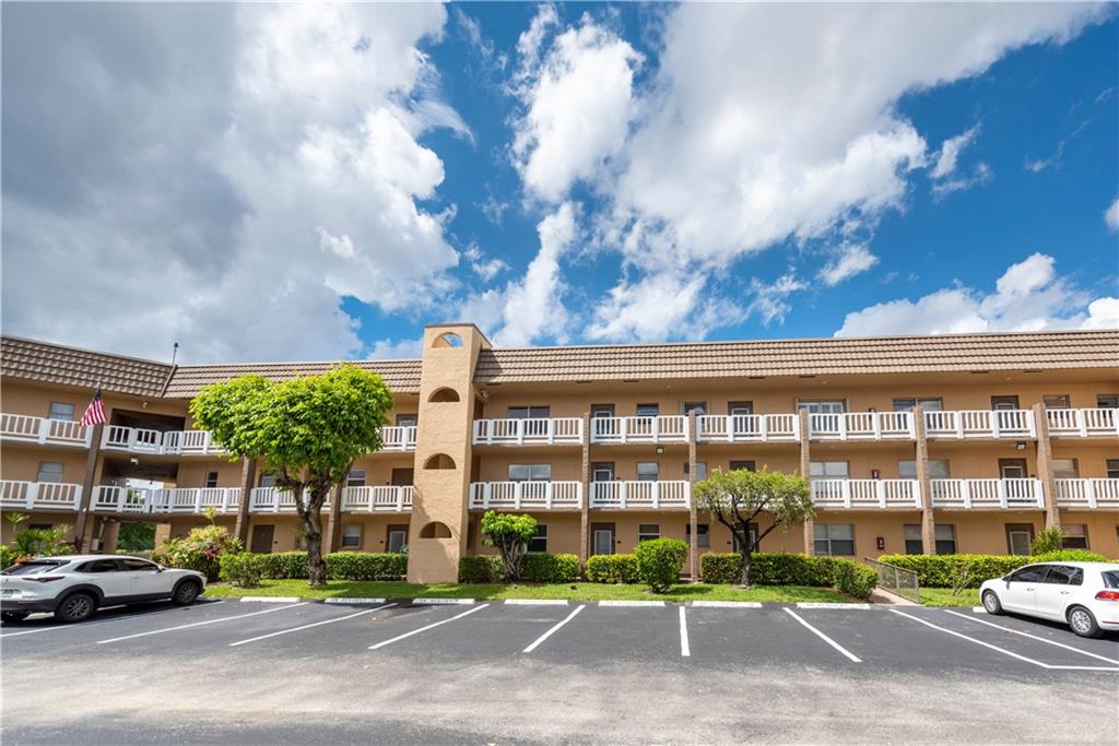 Light, bright with wonderful water views! Relax in this one bedroom, one bathroom, 55+,  Sunrise Lakes Phase 3 condo. Perfect for downsizing or second home. Freshly painted, new carpet and ready for your touches.  Private location off the main street and beautiful wide lake view from living area and bedroom. Mirrored dining wall, tile in foyer, kitchen and bathroom; new carpet in living areas and bedroom. Extended living area with Florida room to enjoy water view. Extra storage space in building. Courtesy bus for complex. Fabulous clubhouses (main and satellite) with many amenities: pools, golf, sauna, tennis, fitness center, shuffleboard, handball, & theater.  Ideal location near Publix, restaurants, shopping and highways. Enjoy a carefree lifestyle in this fabulous community!