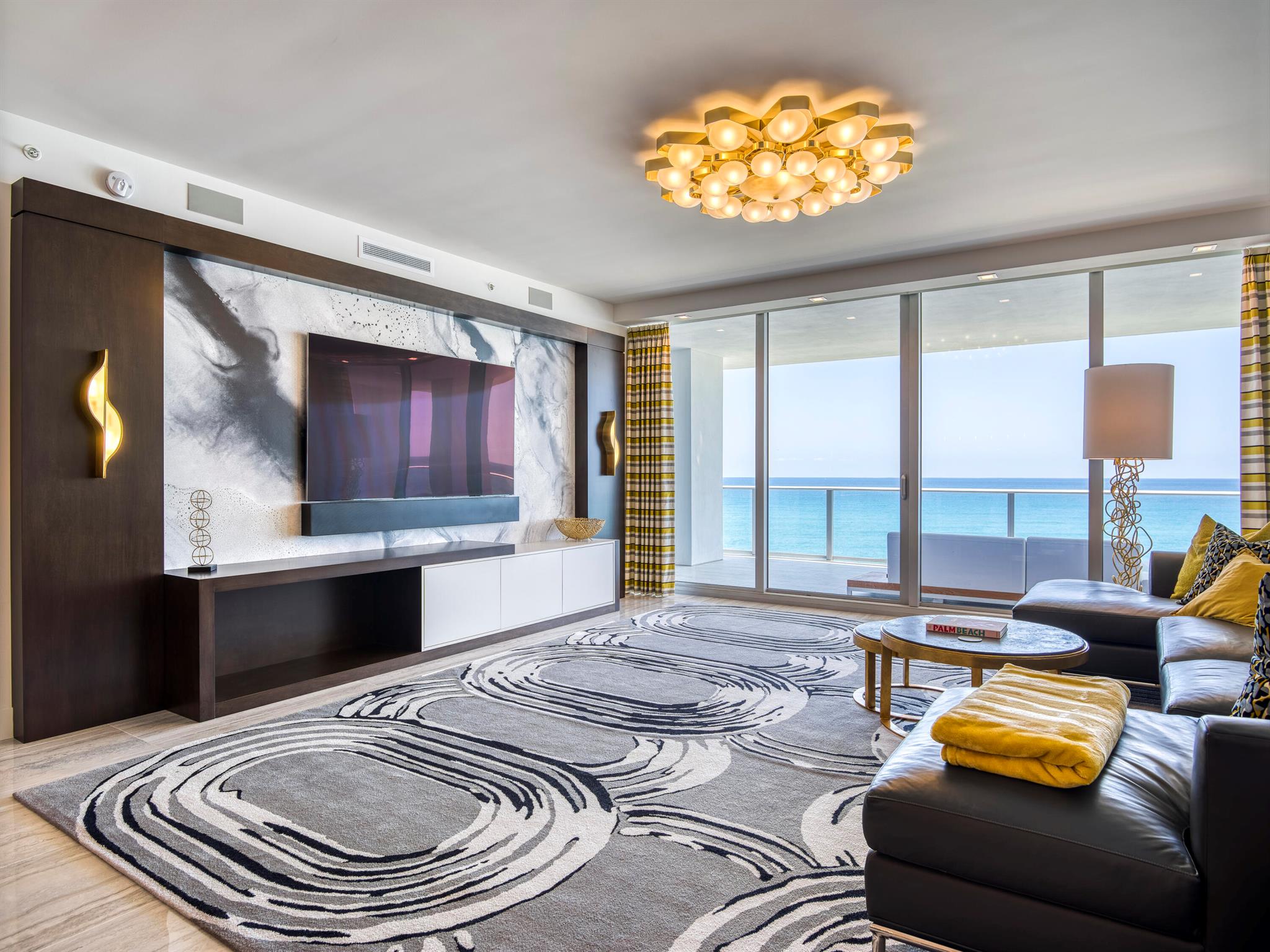 Take your private elevator to this dramatic, turnkey, retro-inspired oceanfront condo in the heart of Singer Island!  Featured in Florida Living Magazine and designed by ASID Design Award Winner, Lorraine Rogers, this oceanfront masterpiece features over $1 million in custom upgrades including geometric, veneered walls, custom silk and wool rugs, and lighting from all over the world to suit the needs of the homeowners who used the unit as their oceanfront pied-à-terre.  Additionally, the entire unit was pre-wired for Control 4 and Lutron technology which allows you to control music, TVs, blackout shades, drapery, lighting, wireless thermostat from your mobile device, installed control panel and touch panels throughout the unit.  Watch the magnificent, unobstructed sunrise over the Atlantic Ocean from your 500 square foot balcony.