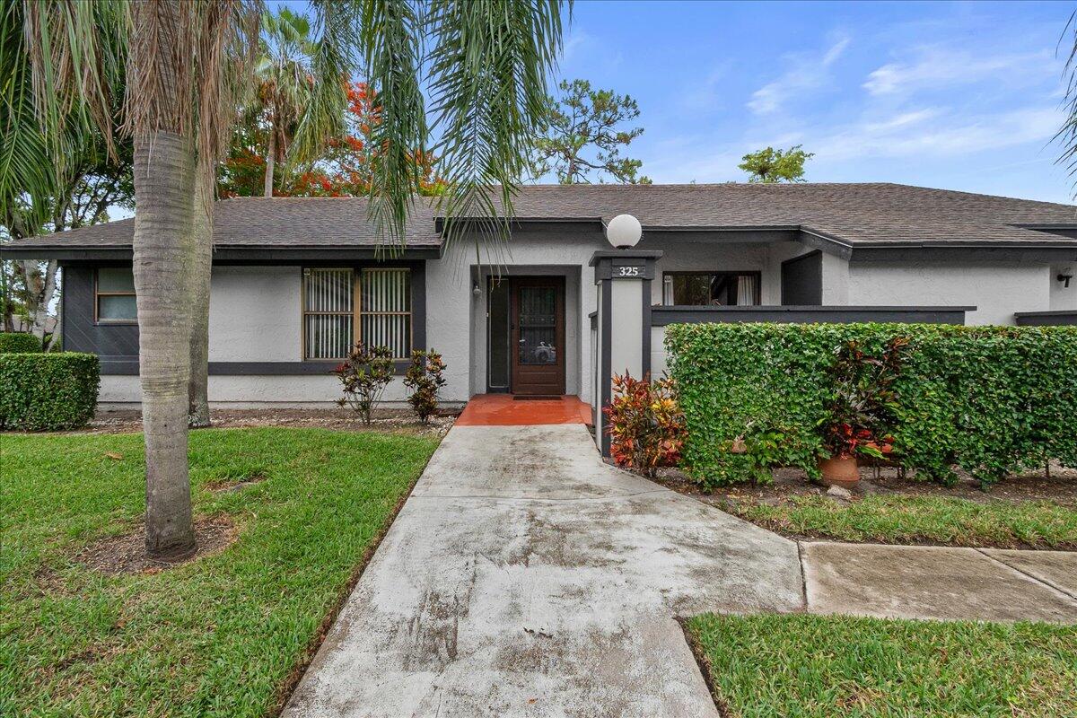 Welcome to Strathmore Gate West, a active adult community in the heart of Royal Palm Beach. This 3-bedroom, 2-bath end unit villa is ready for your personal touches. The home features vinyl flooring throughout, a laundry closet, a fully equipped kitchen with wood cabinetry, granite countertops, & a pantry, & a 2nd bath that was recently renovated. The spacious primary suite offers two closets & a vanity area with double sinks. One assigned parking space included, with ample guest parking available. Residents can enjoy the community clubhouse, fitness center, two heated pools, & numerous social activities. Conveniently located near shopping, dining, parks, & everything Royal Palm Beach has to offer, this charming home is the perfect blend of comfort, convenience, & community living.